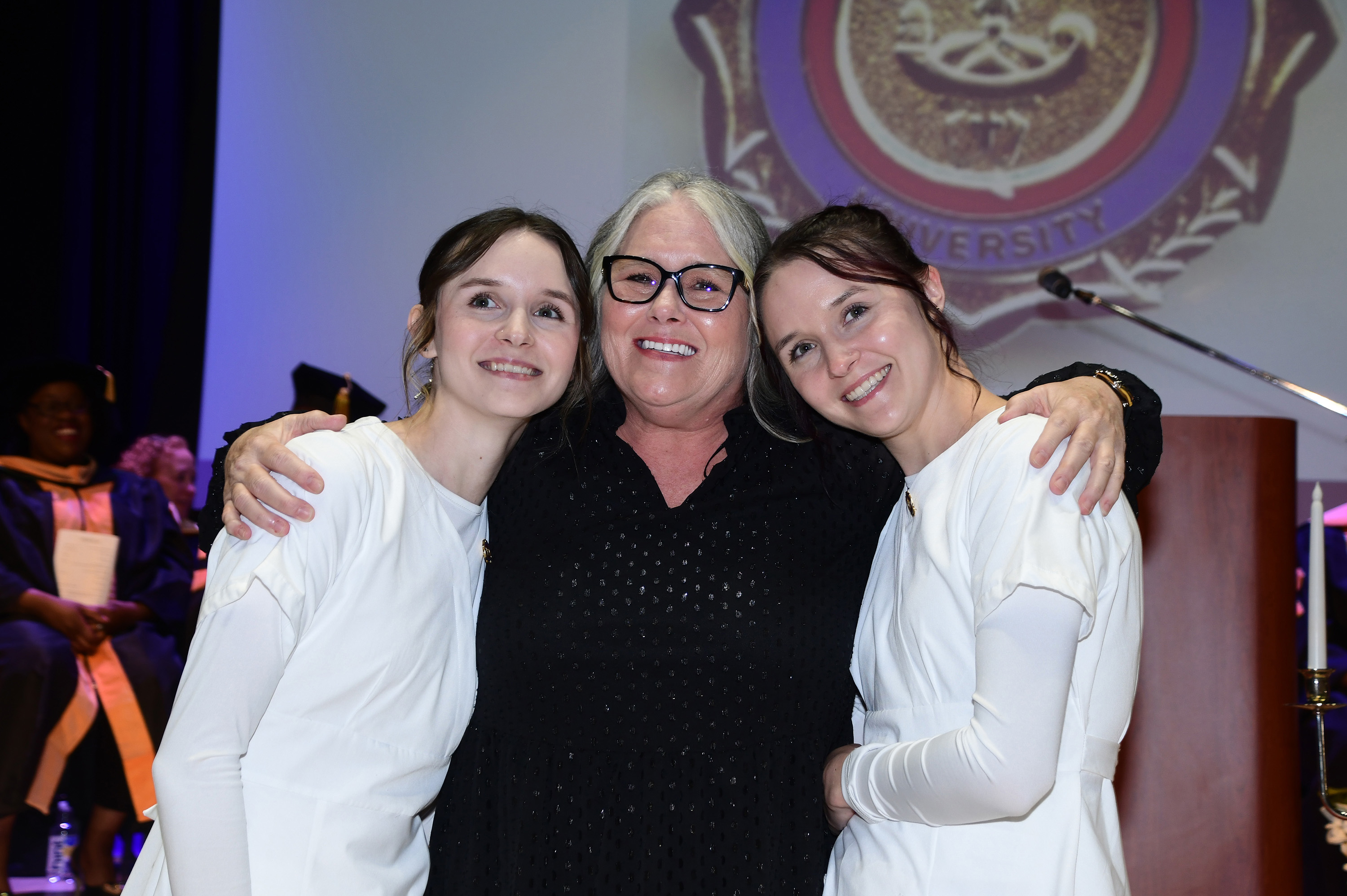 Shari Keller poses with her twin daughters Megan and Misty after giving them their nursing pins.