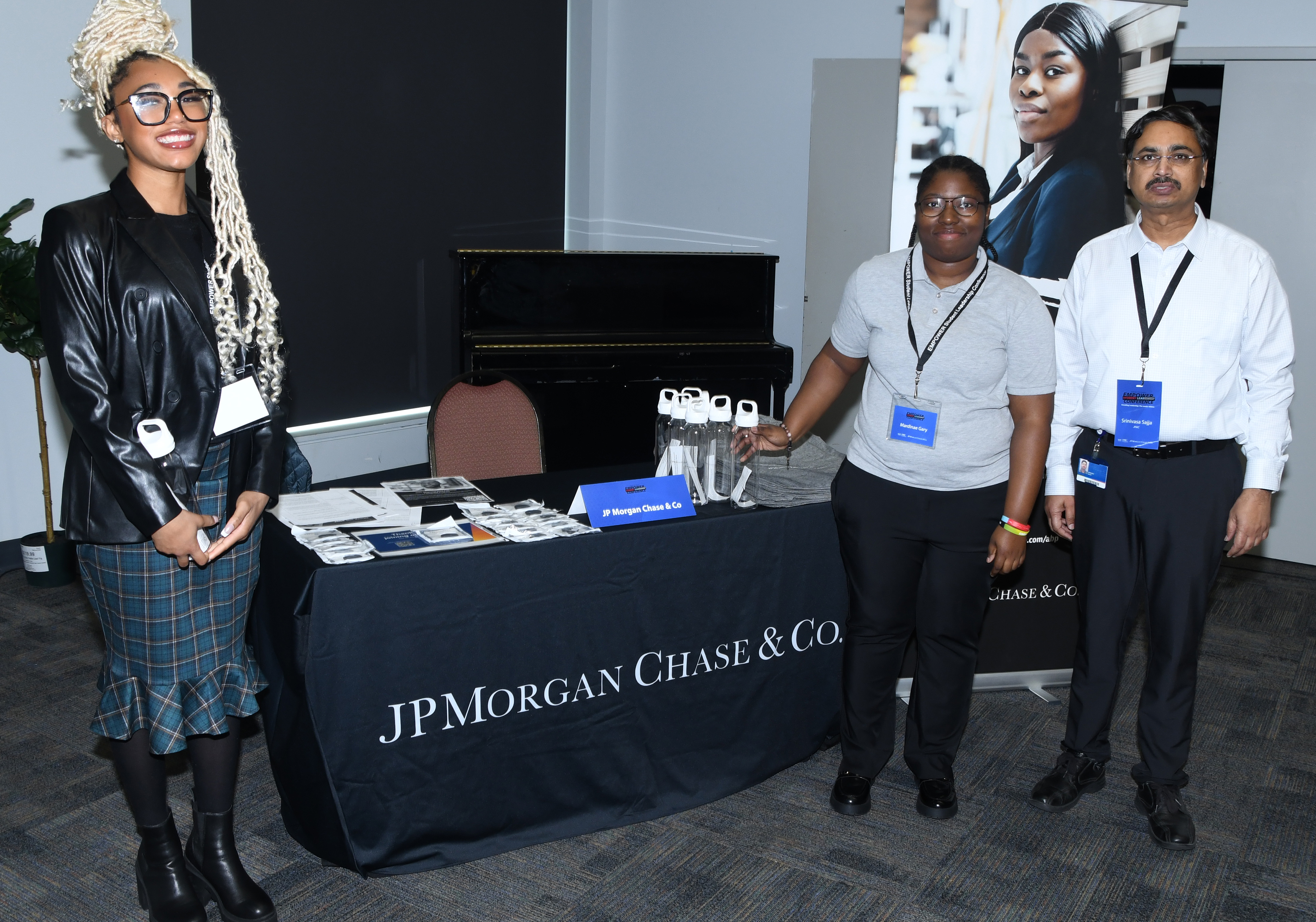 Two student pose with a representative of JP Morgan Chase, which sponsor the event's Jan. 31 networking lunch.