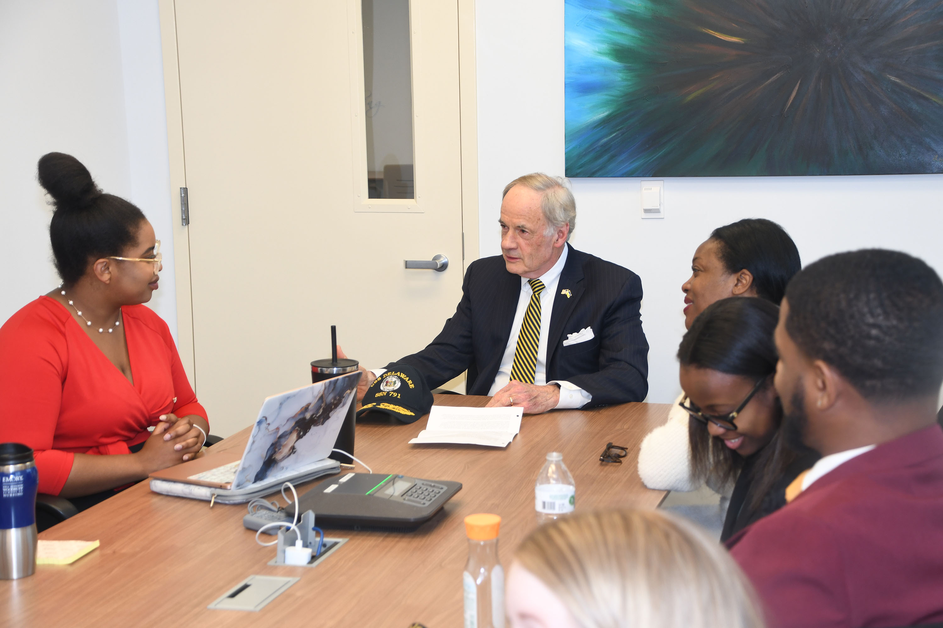 Sen. Tom Carper receives a briefing from the DSU students on the Alaska environmental concerns.