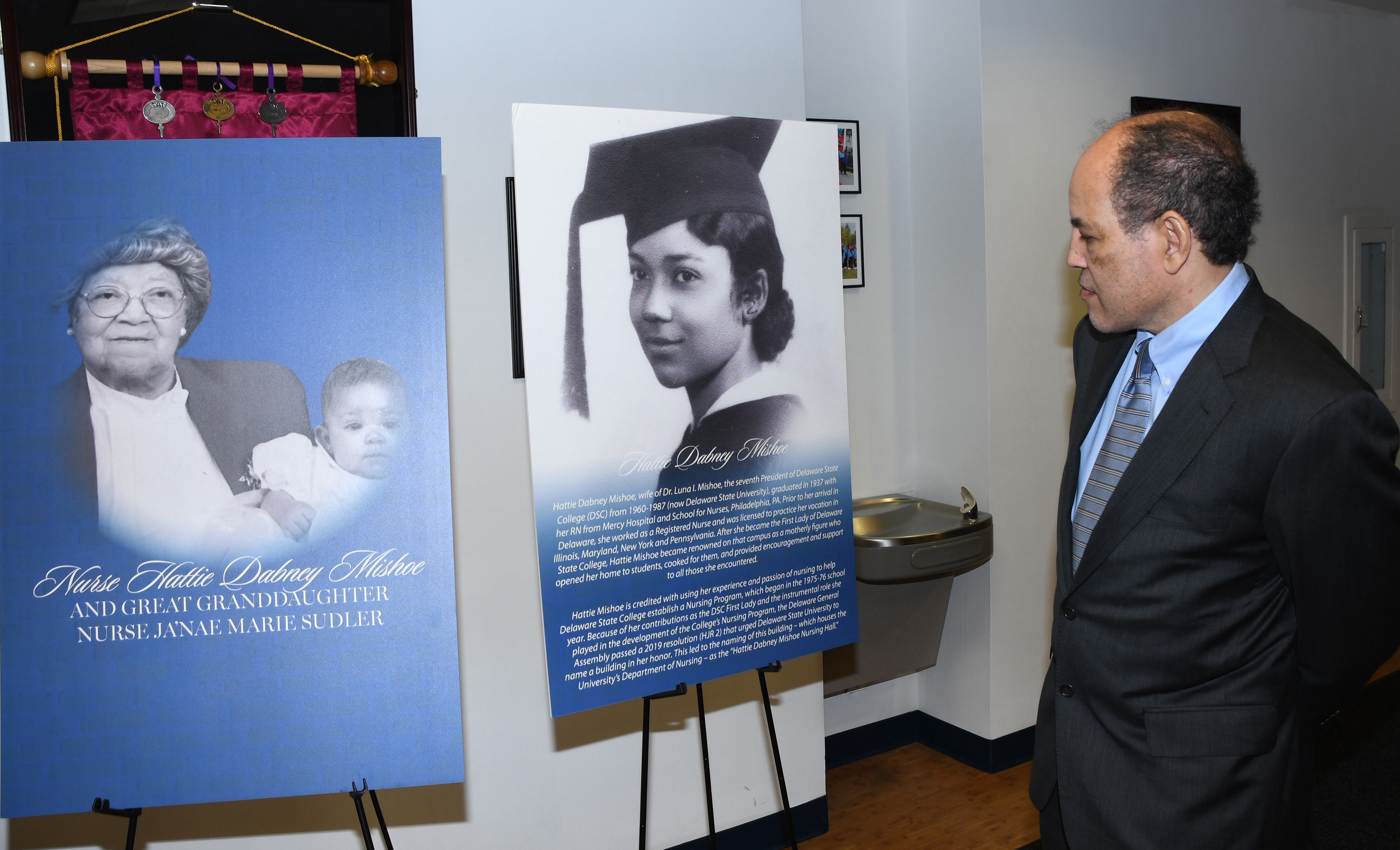 A relative of Hattie Dabney Mishoe looks at a display that tells of her life.