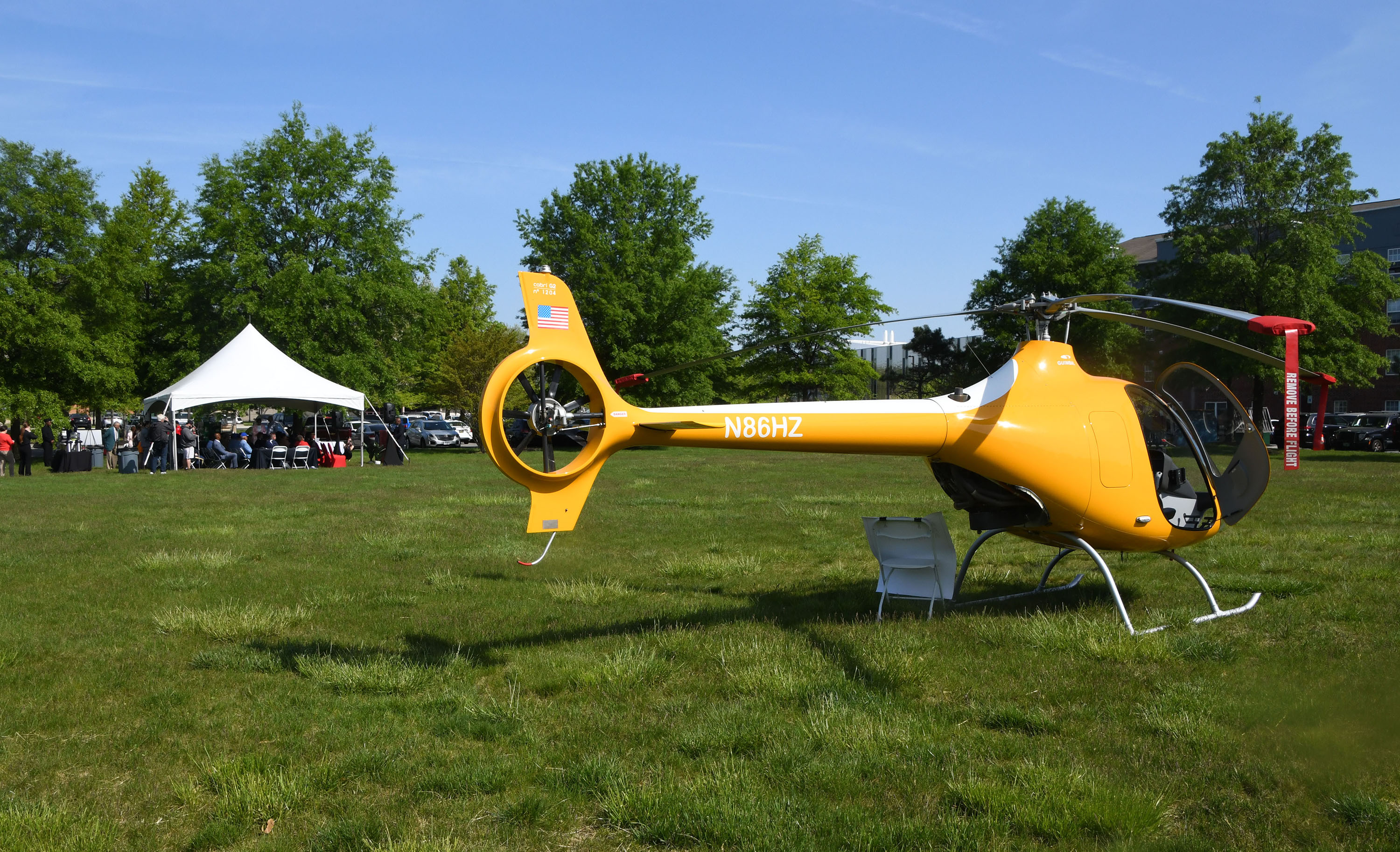 A Cabri G2 Helicopter, which will be used for the training program, sit in the field near the media event.