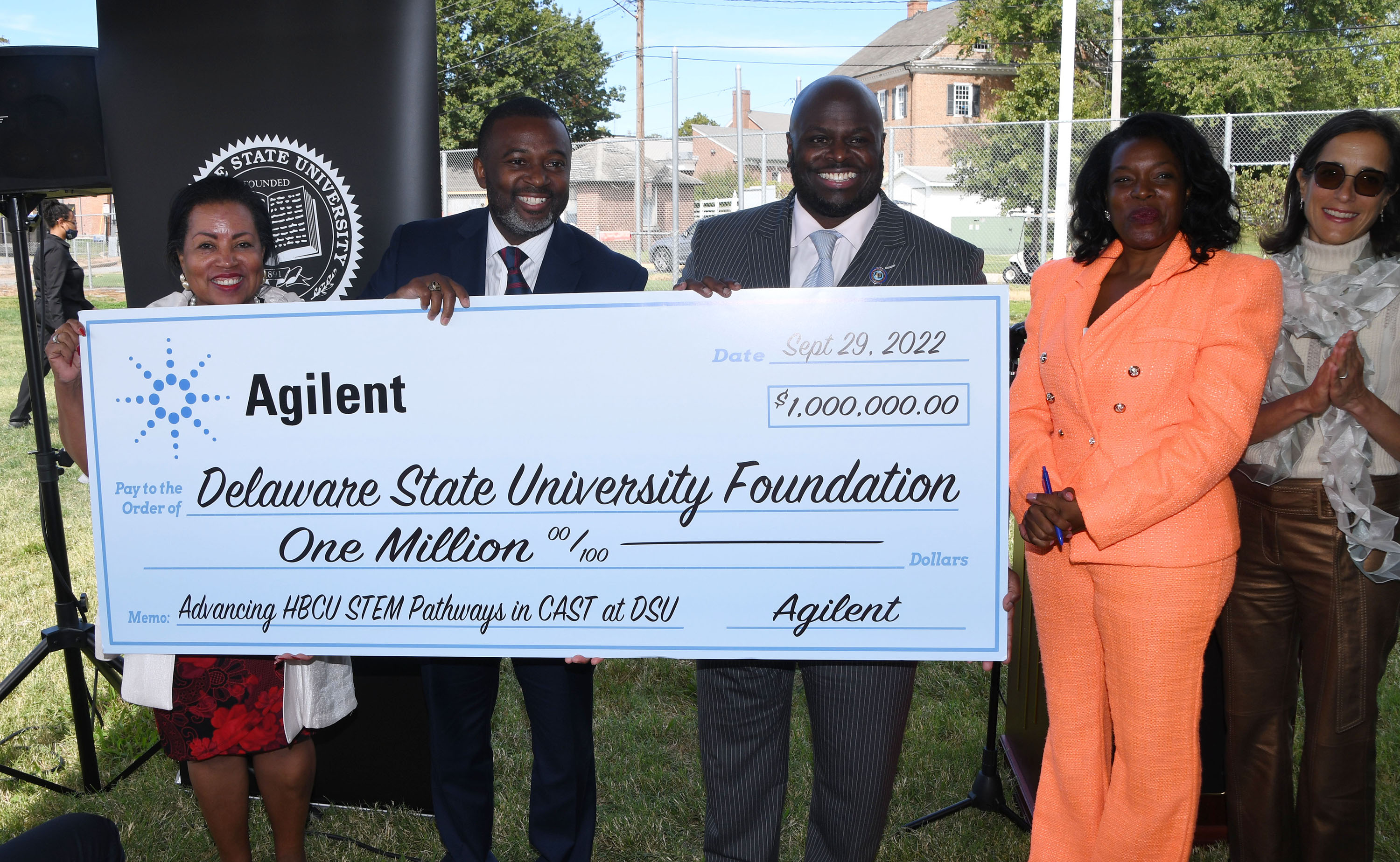 University and Agilent officials hold a display check symbolizing the M donation.