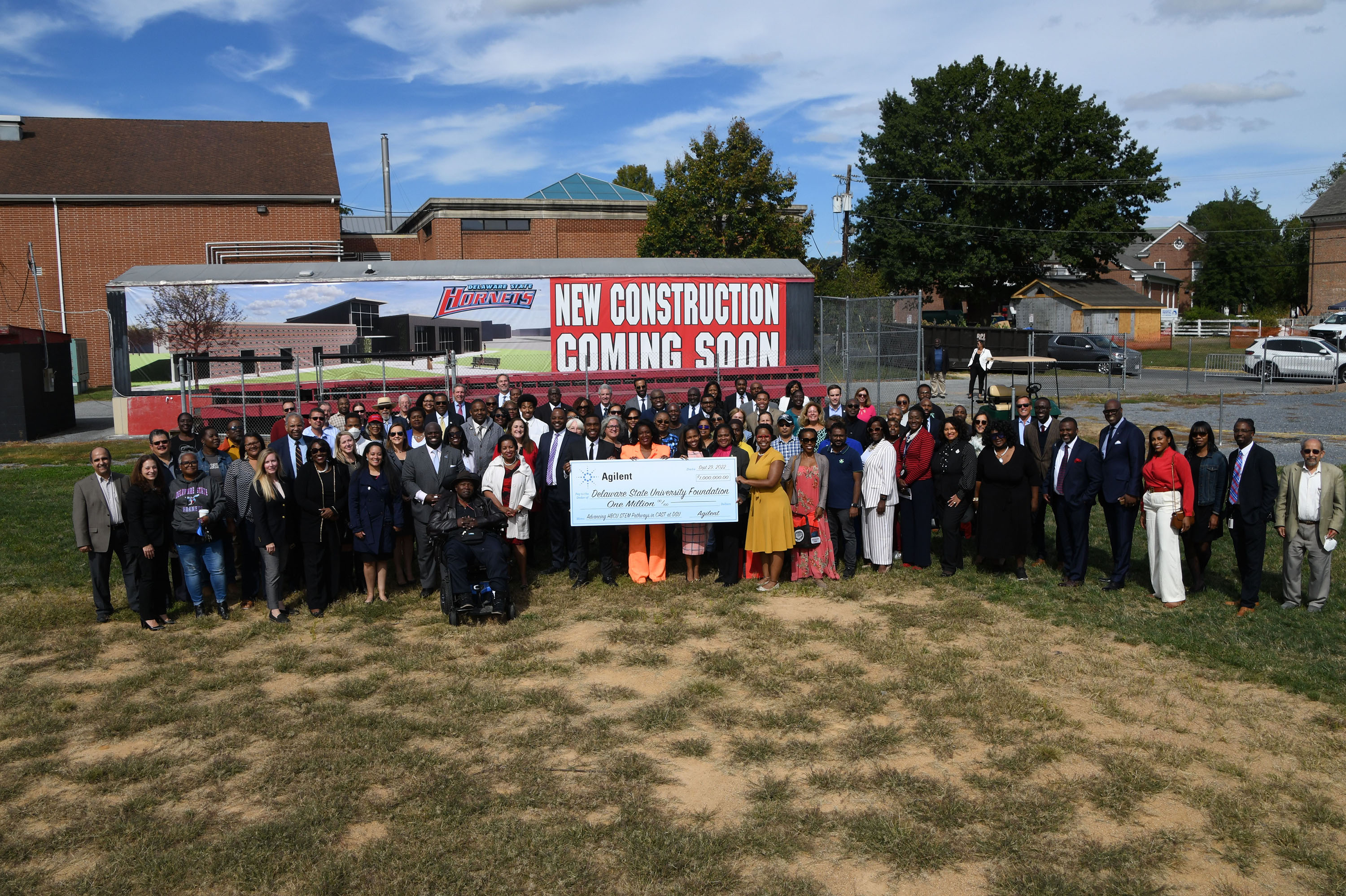 Many of the groundbreaking attendees posed in front of the Ag Bldg. rendition.
