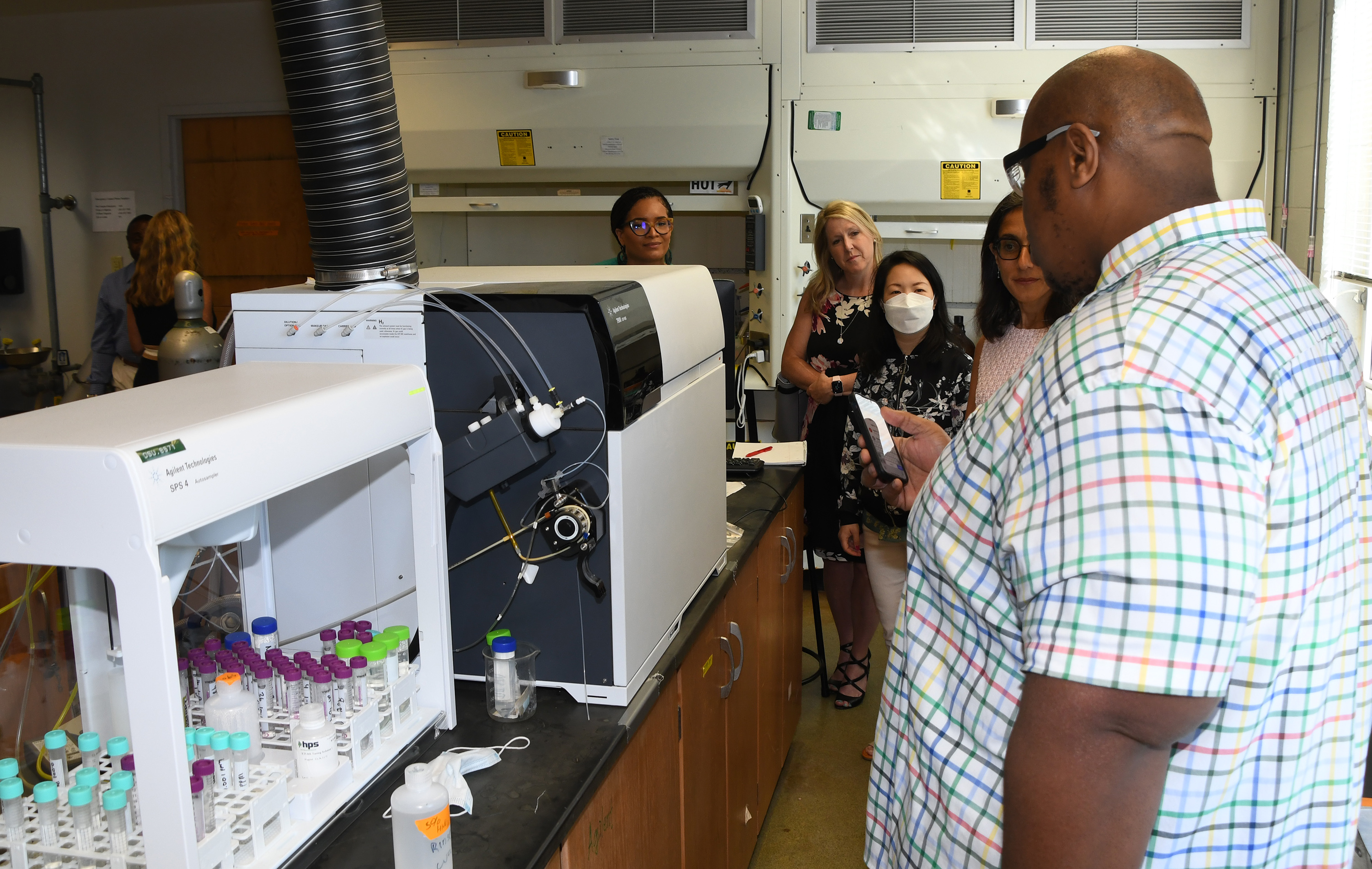 A University graduate student shows Agilent reps some of the laboratory technology in the Mishoe Science Center.