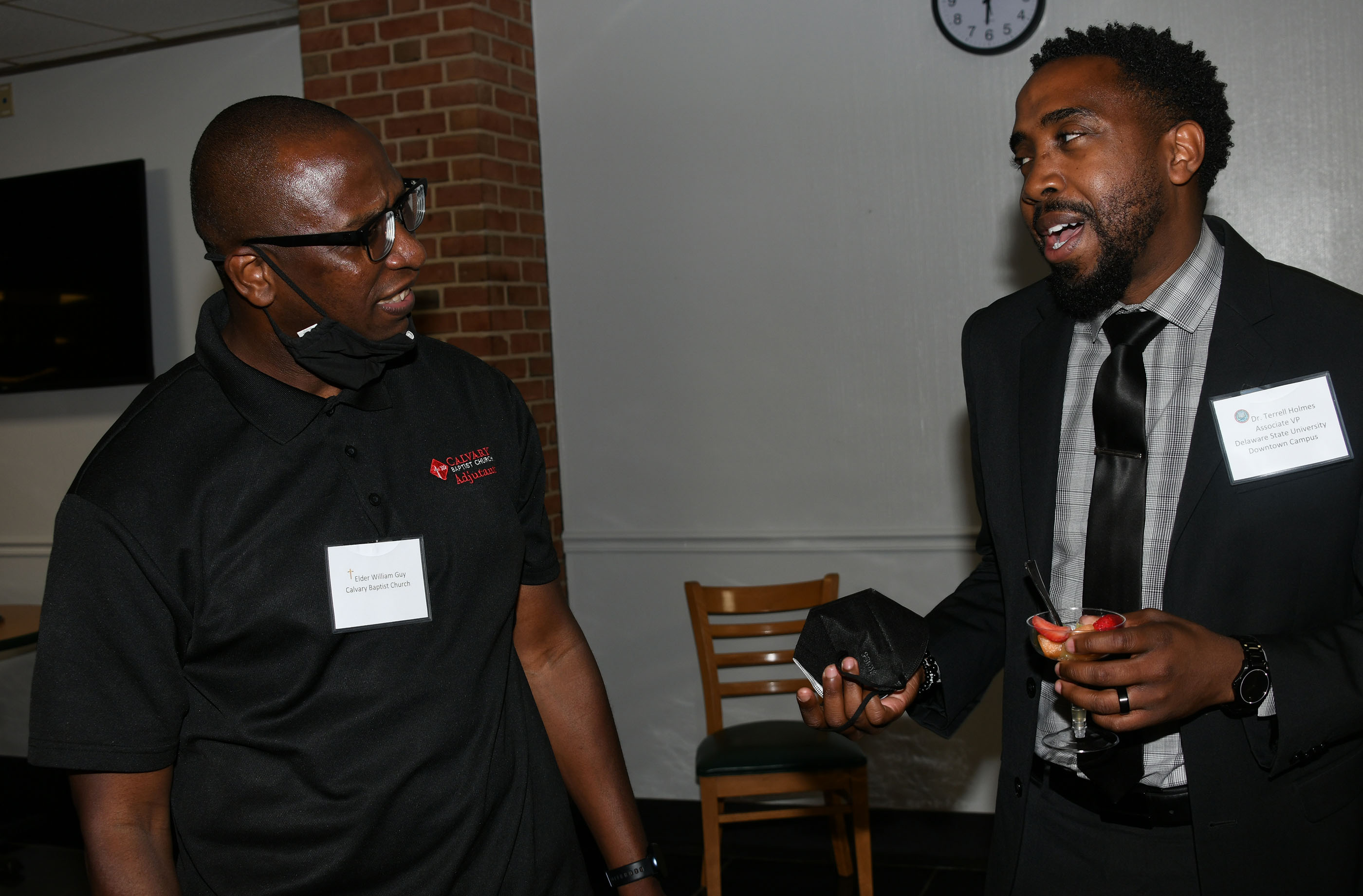 Elder William Guy of Calvary Baptist Church chats with Del State's Dr. Terrell Holmes