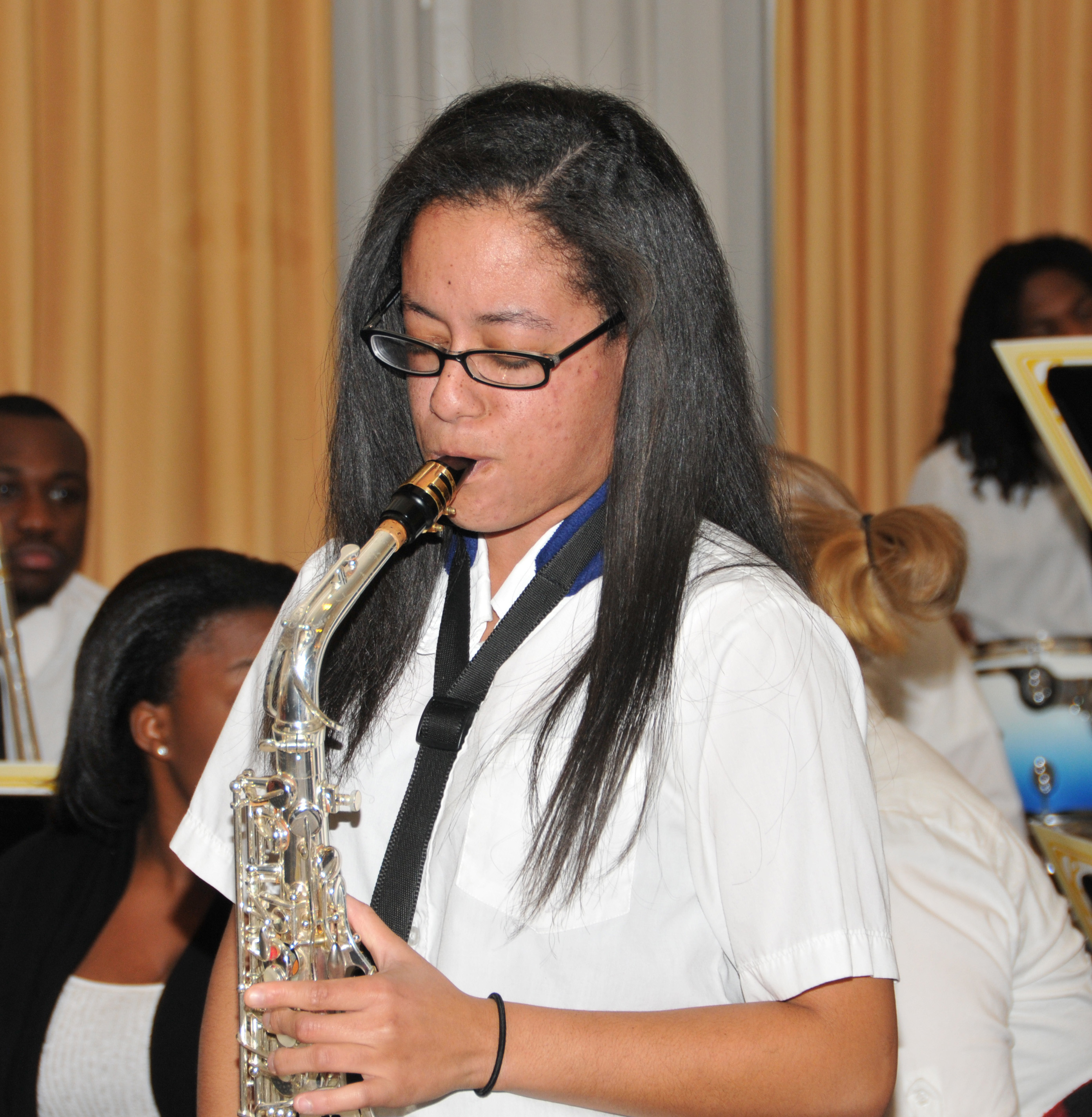 Ms. Williams, shown as a freshman in 2012 playing as sax solo with the Univ. Jazz Band. She plays nine instruments.