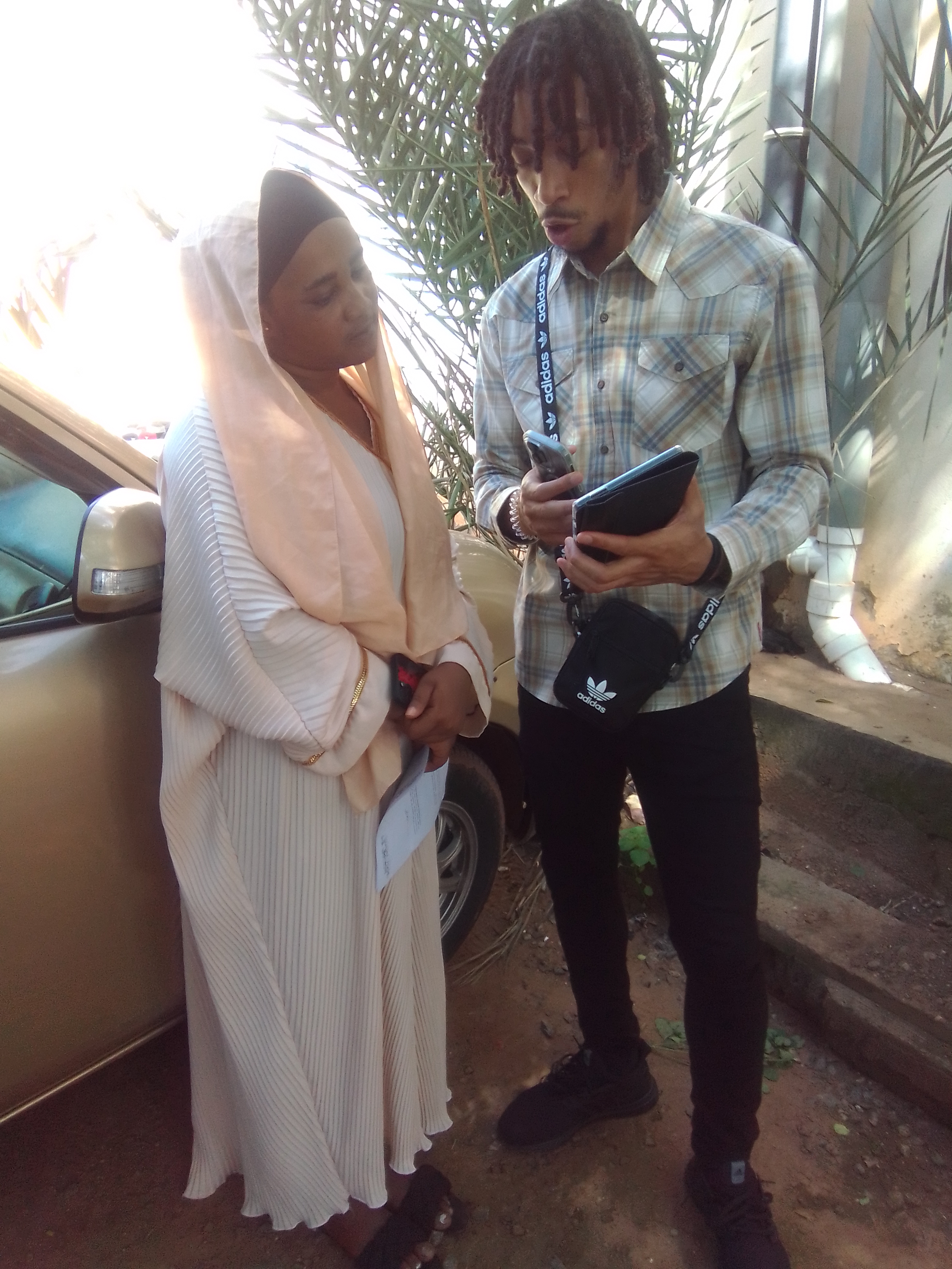 Christopher Lewis, a senior Criminal Justice major, poses survey question to a Ghanaian woman.