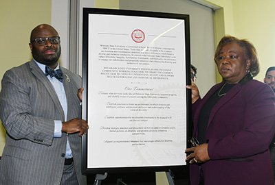 University President Tony Allen and Dr. Irene Chapman-Hawkins, chief administrative officer, hold the proclamation.