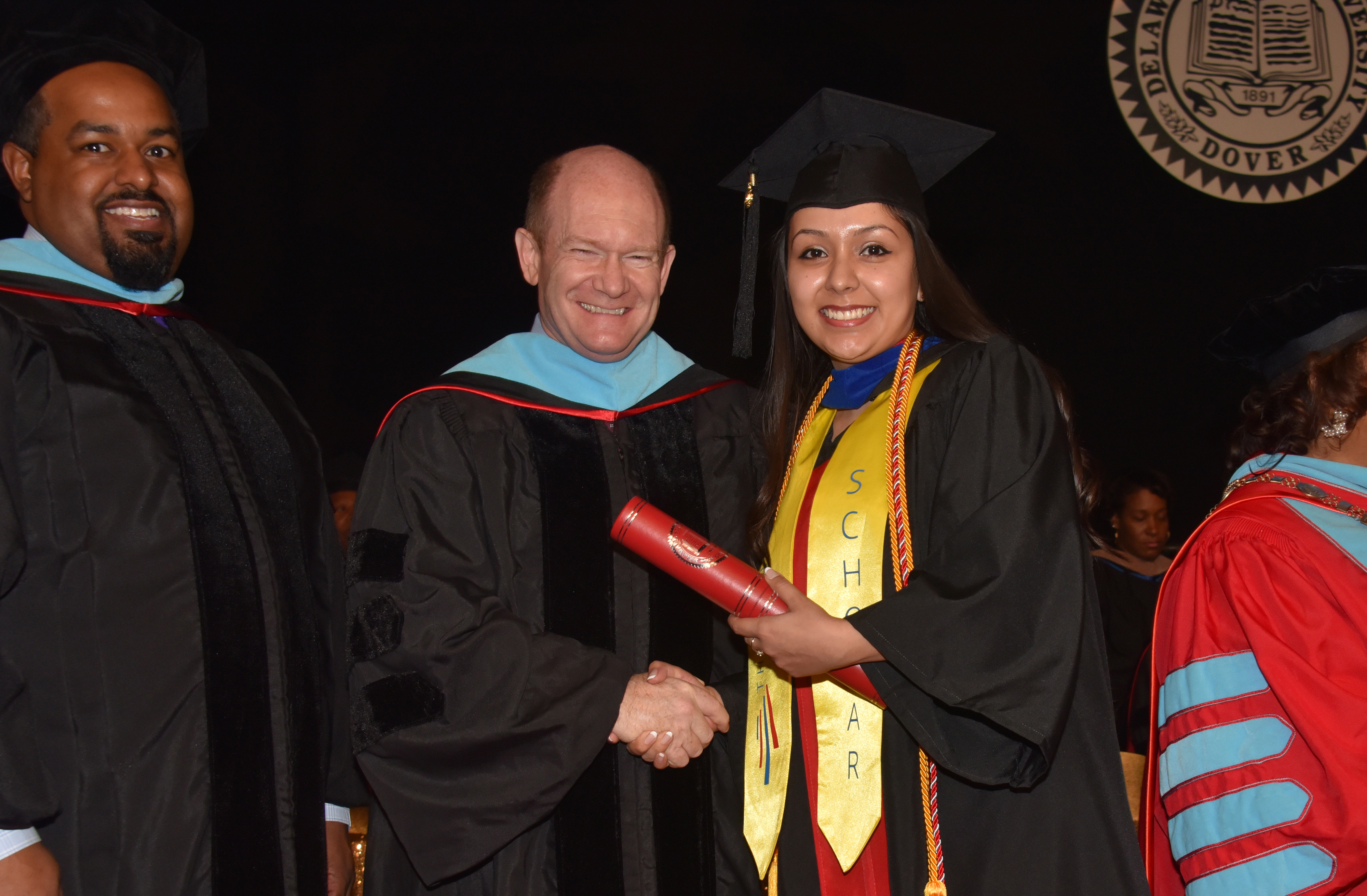 U.S. Sen. Chris Coons poses with Dulce Guerrero at the Dec. 14 Commencement Ceremony, where she became the first Opportunity Scholarship Dreamer to receive her bachelor's degree at Delaware State University.