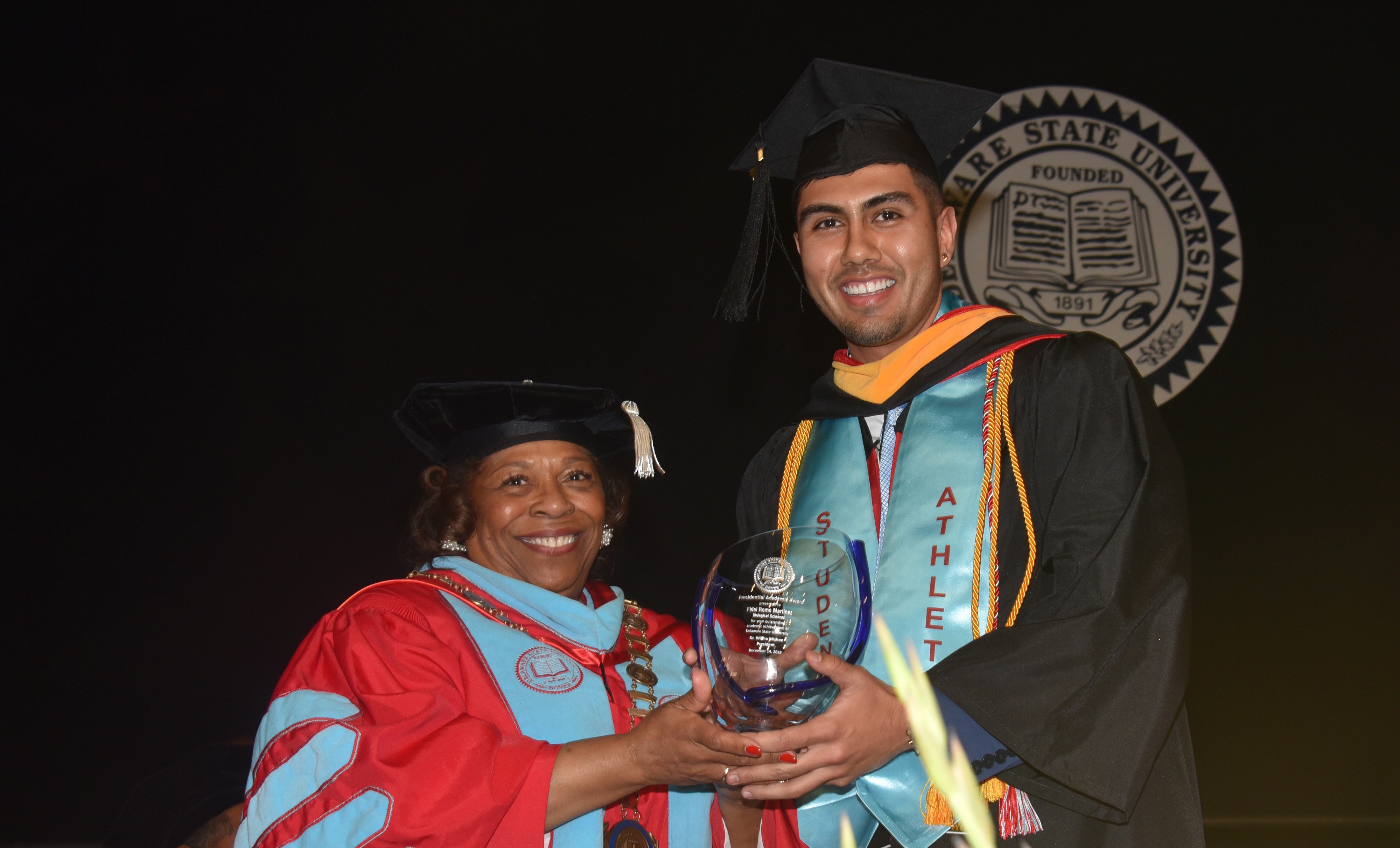 University President Wilma Mishoe presents Fidel Romo-Martinez with the Presidential Academic Award. As a Biological Sciences major, Mr. Romo-Martinez carried a 4.0 GPA throughout his entire undergraduate journey.