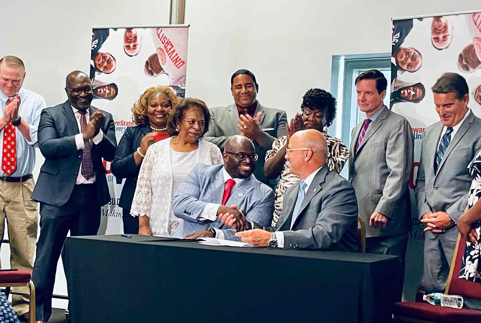 University President Tony Allen and Wesley College President Bob Clark sit together during the July 1 Del State forum where the finalization of the Wesley acquisition was celebrated.