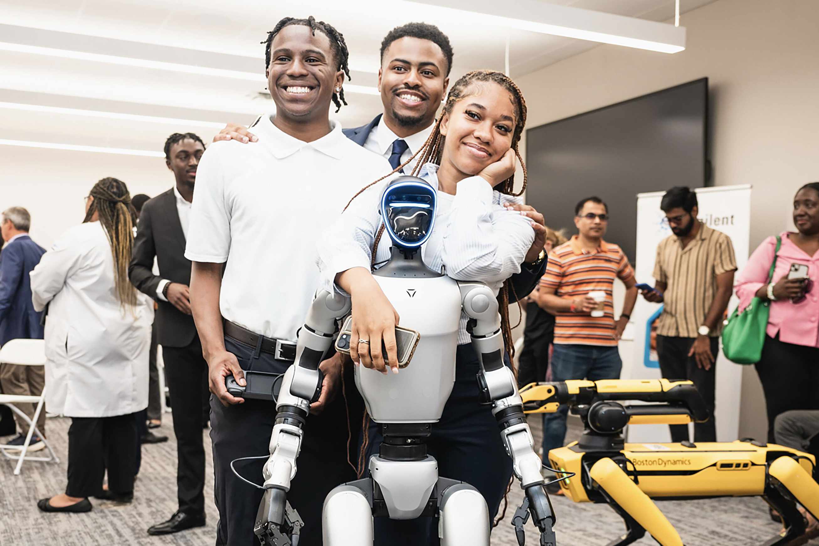 DSU students pose with robotics technology during the Agilent Hub for Agriculture, Innovation and Extension dedication at Delaware State University.