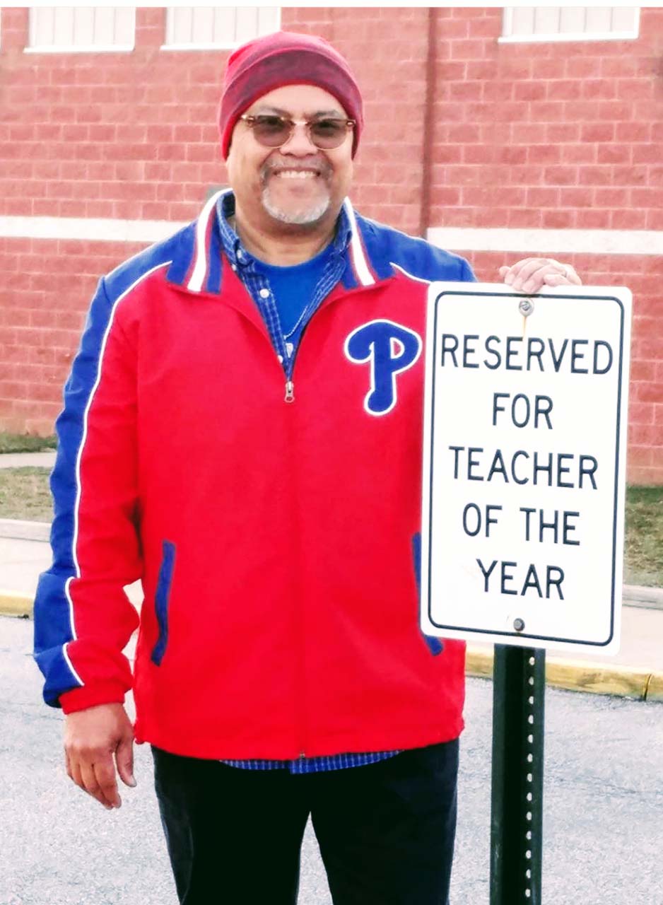 Milton Downing shows parking privileges come with Teacher of the Year honors.