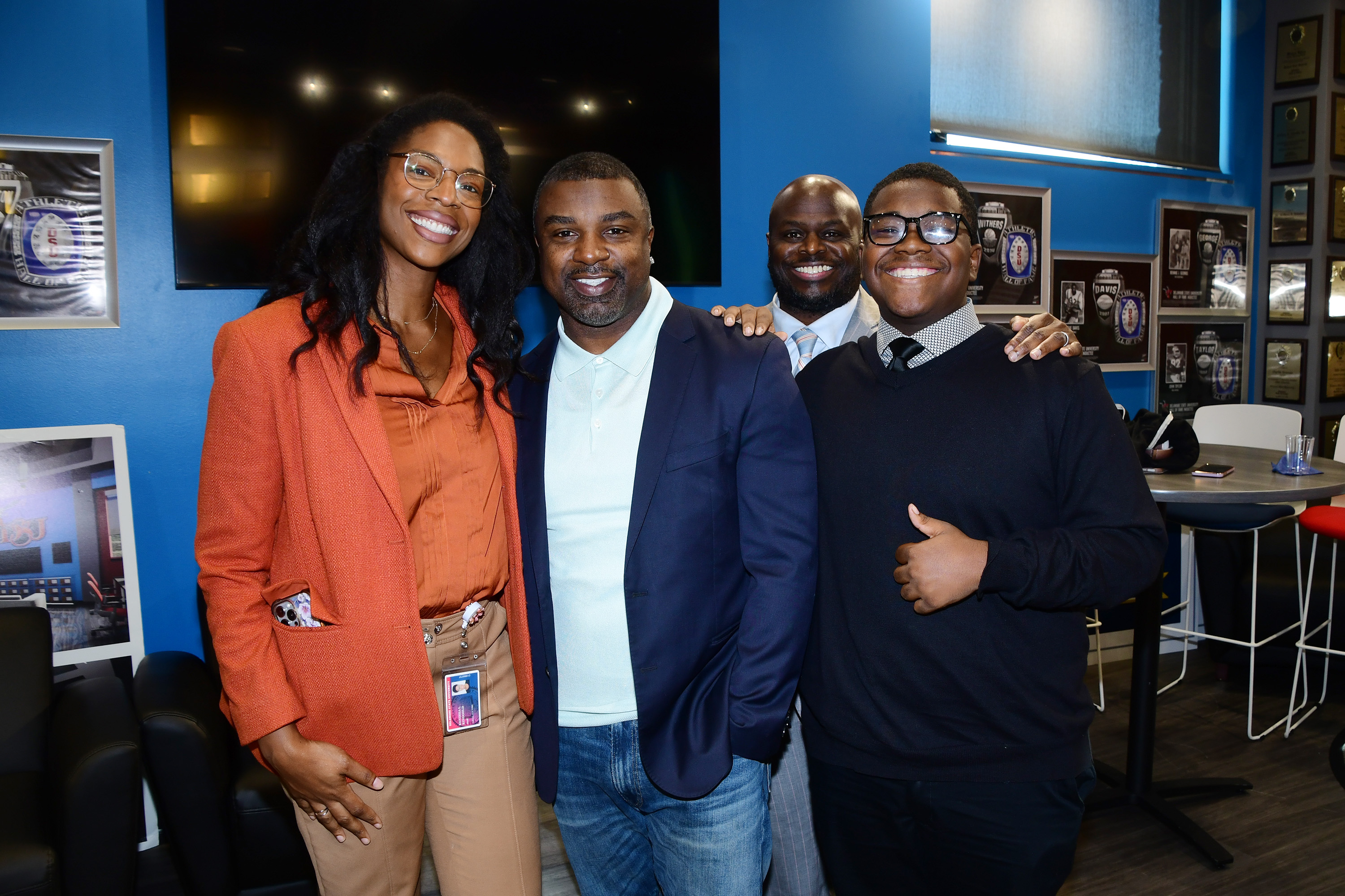 DSU's Kenisha Ringgold, former Philly Eagles star Brian Westbrook, DSU President Tony Allen and a student pose for a pic.