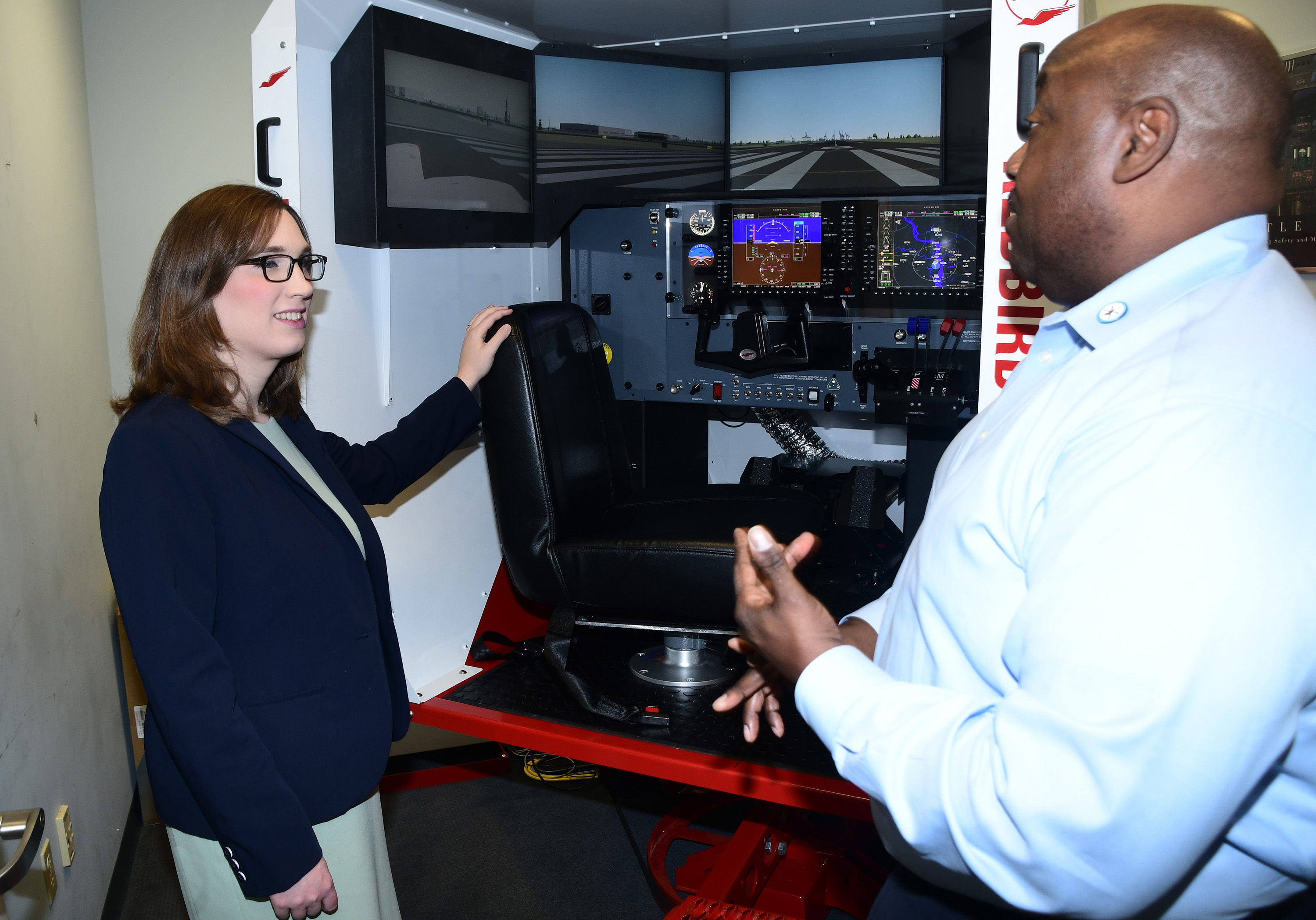 U.S. Rep. Sarah McBride (l) checks out the Aviation Program's flight simulator with Aviation Director C.J. Charlton
