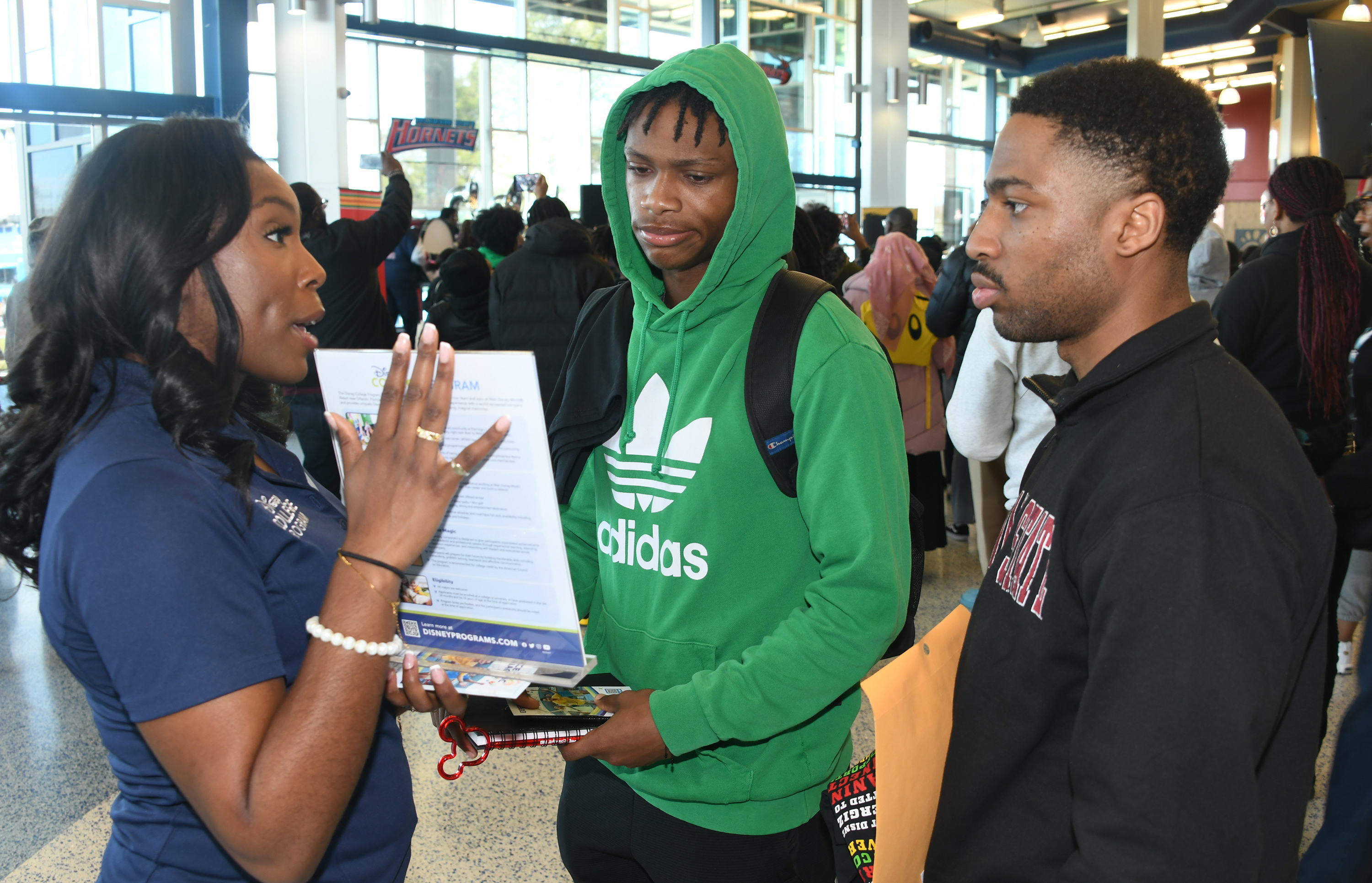 A Disney official talks with two DSU students during the event.