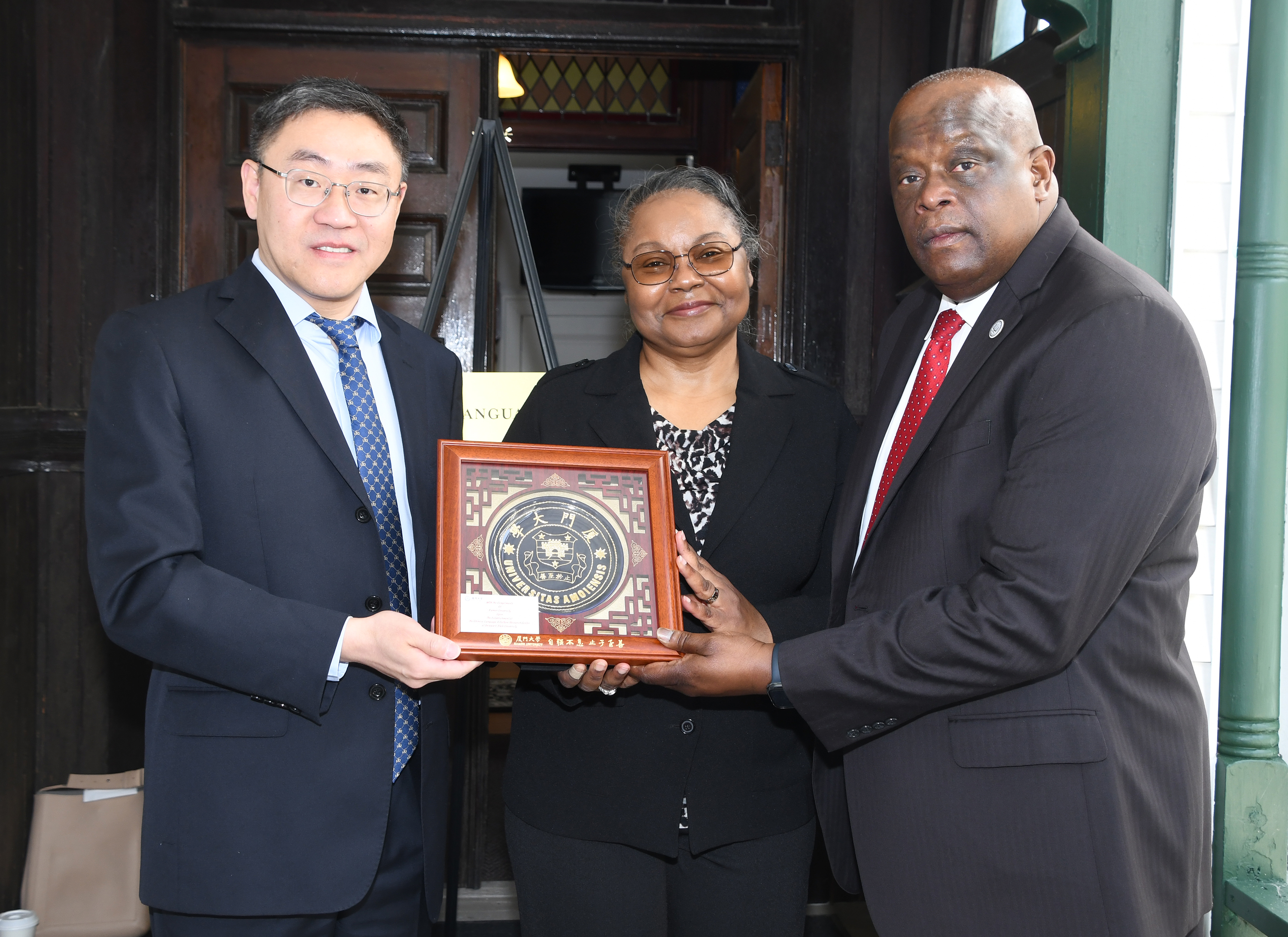 Provost Saundra DeLauder and Tony Boyle accept a gift on behalf of DSU from Dr. Ying Fang (l) of Xiamen University.