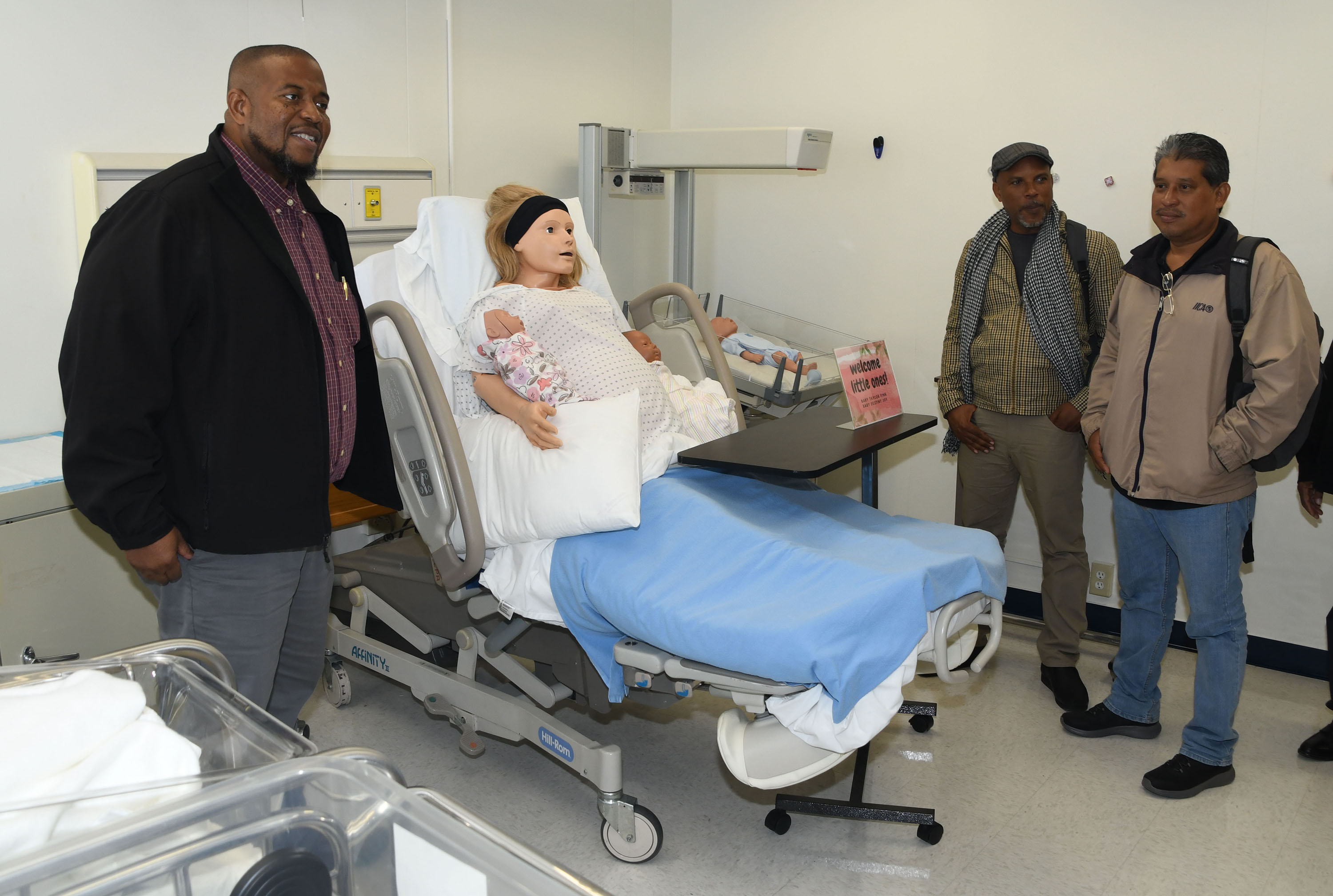 The University of Belize delegation visits a DSU Department of Nursing simulation room . 