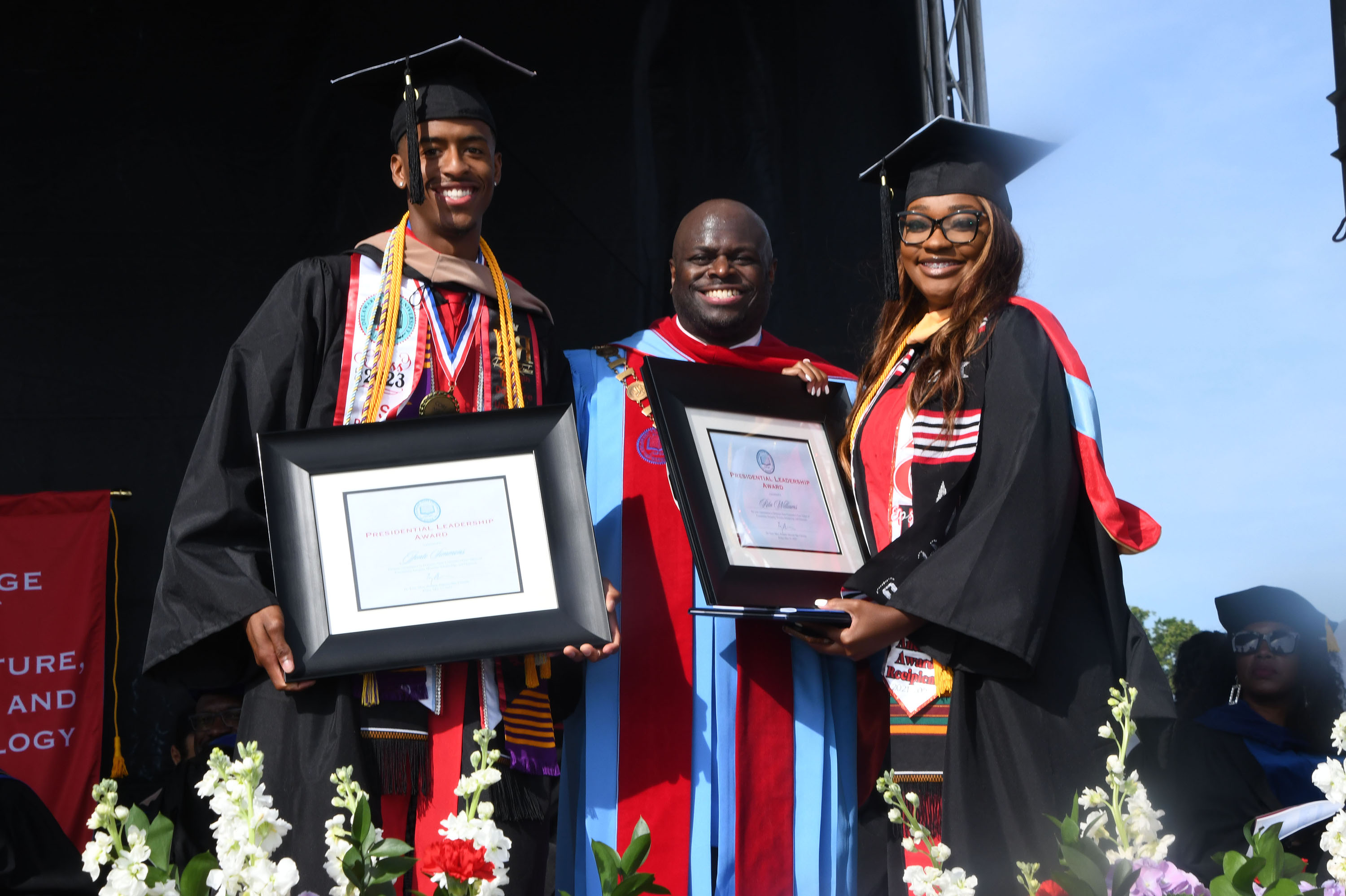 Jonte Simmons (l) and Rita Williams (r) receive the Presidential Leadership Award from Dr. Tony Allen.