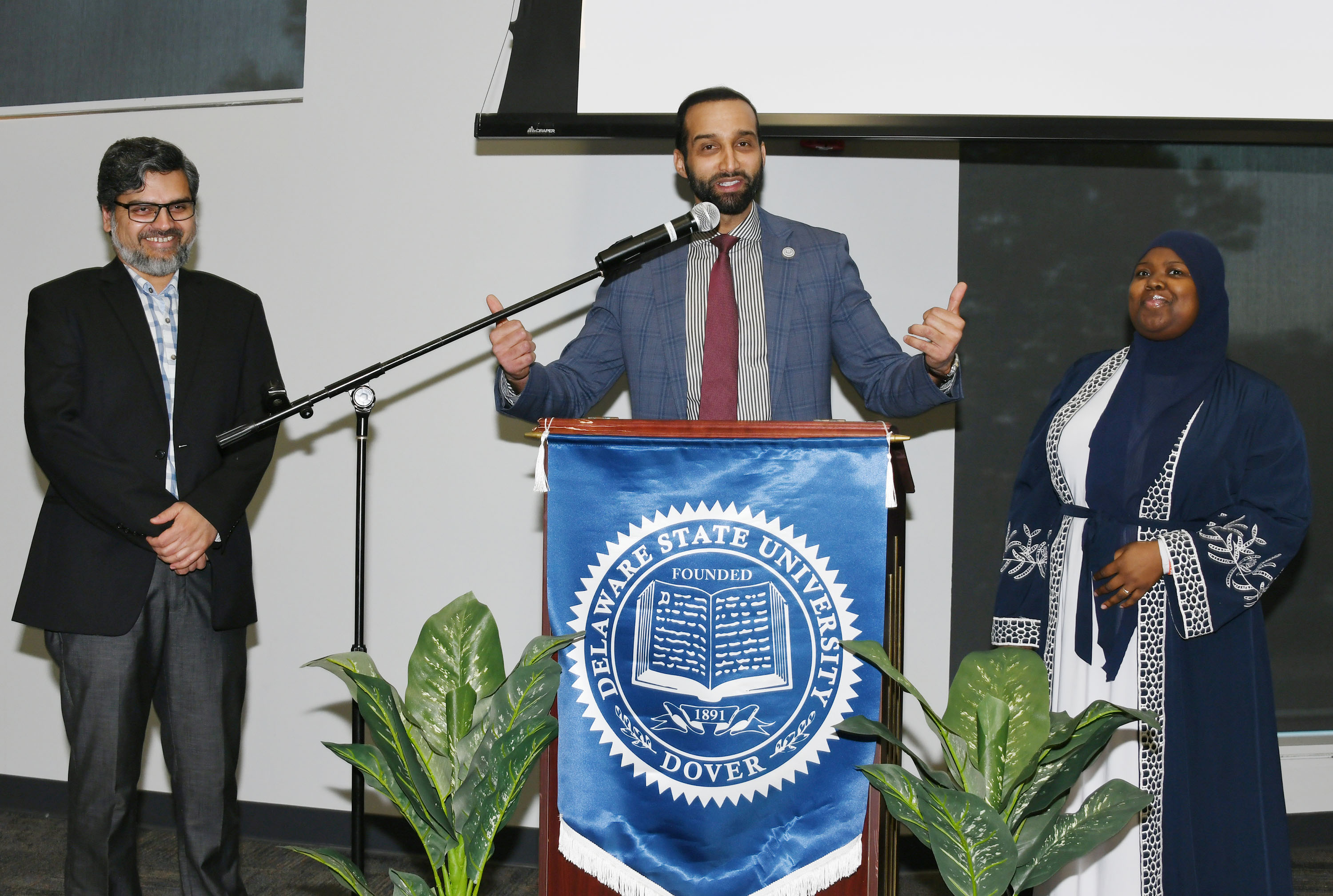 Anas Ben Addi speaks during the Ramadan celebration, flanked by Dr. Mohammed Khan and Tasiyah Sheppard.