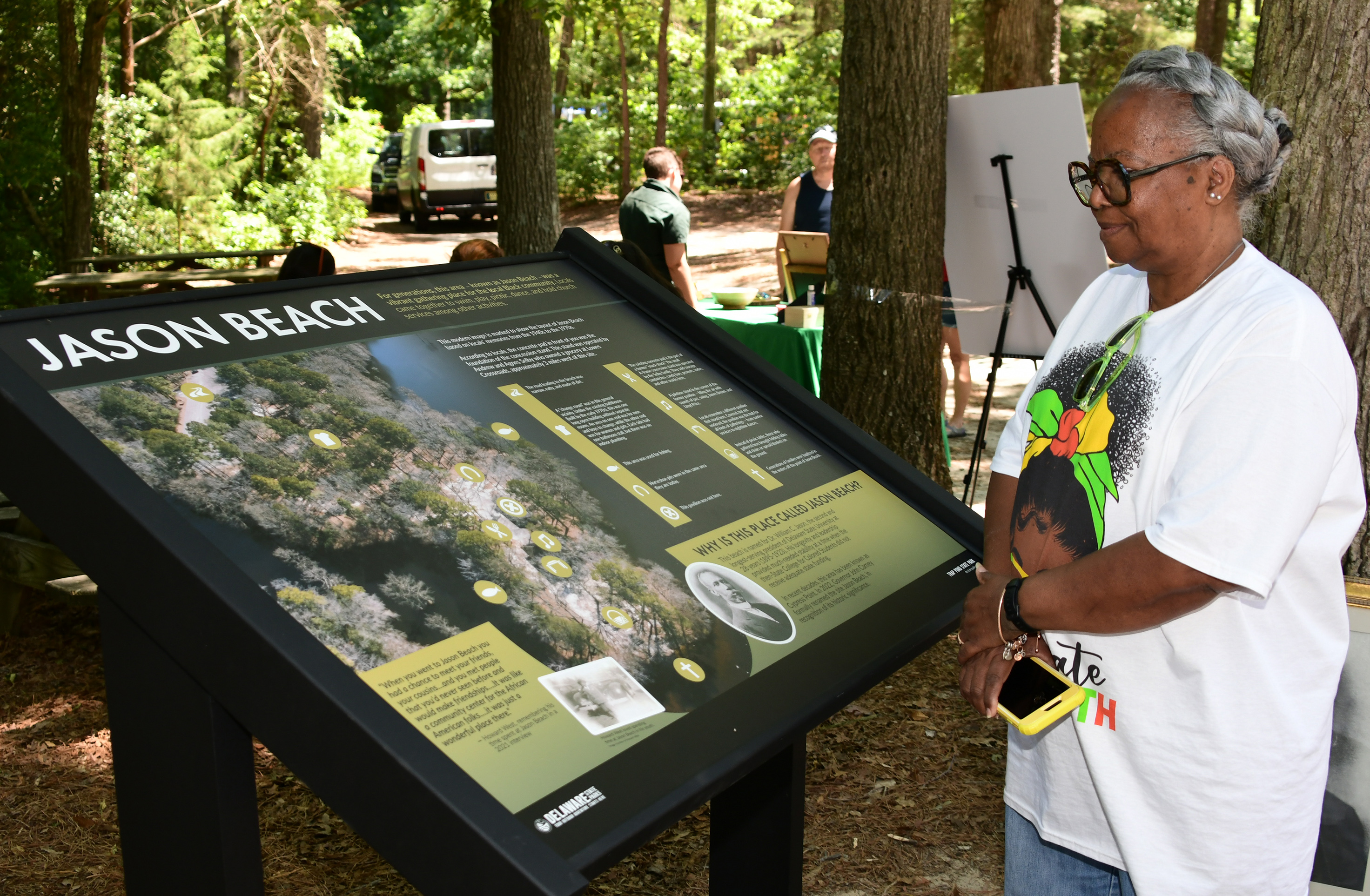 University alumna Beverly C. Banks reviews the Jason Beach information panel.