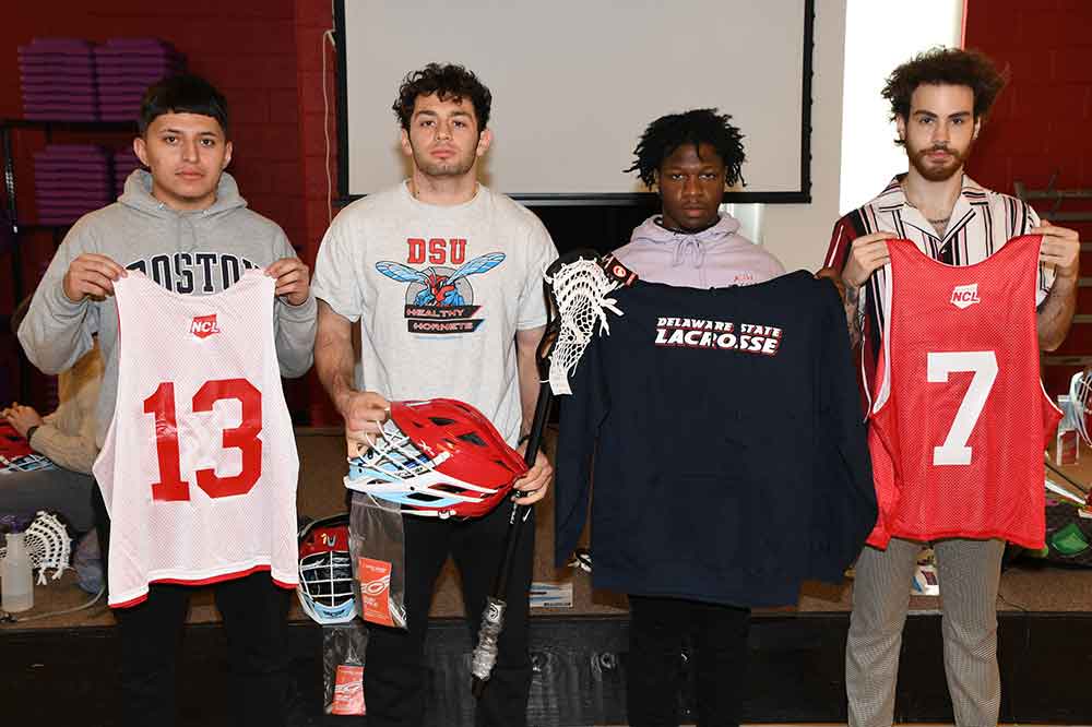 Members of the Men's Lacrosse Sports Team show some of the equipment donated to their team by NLSE.