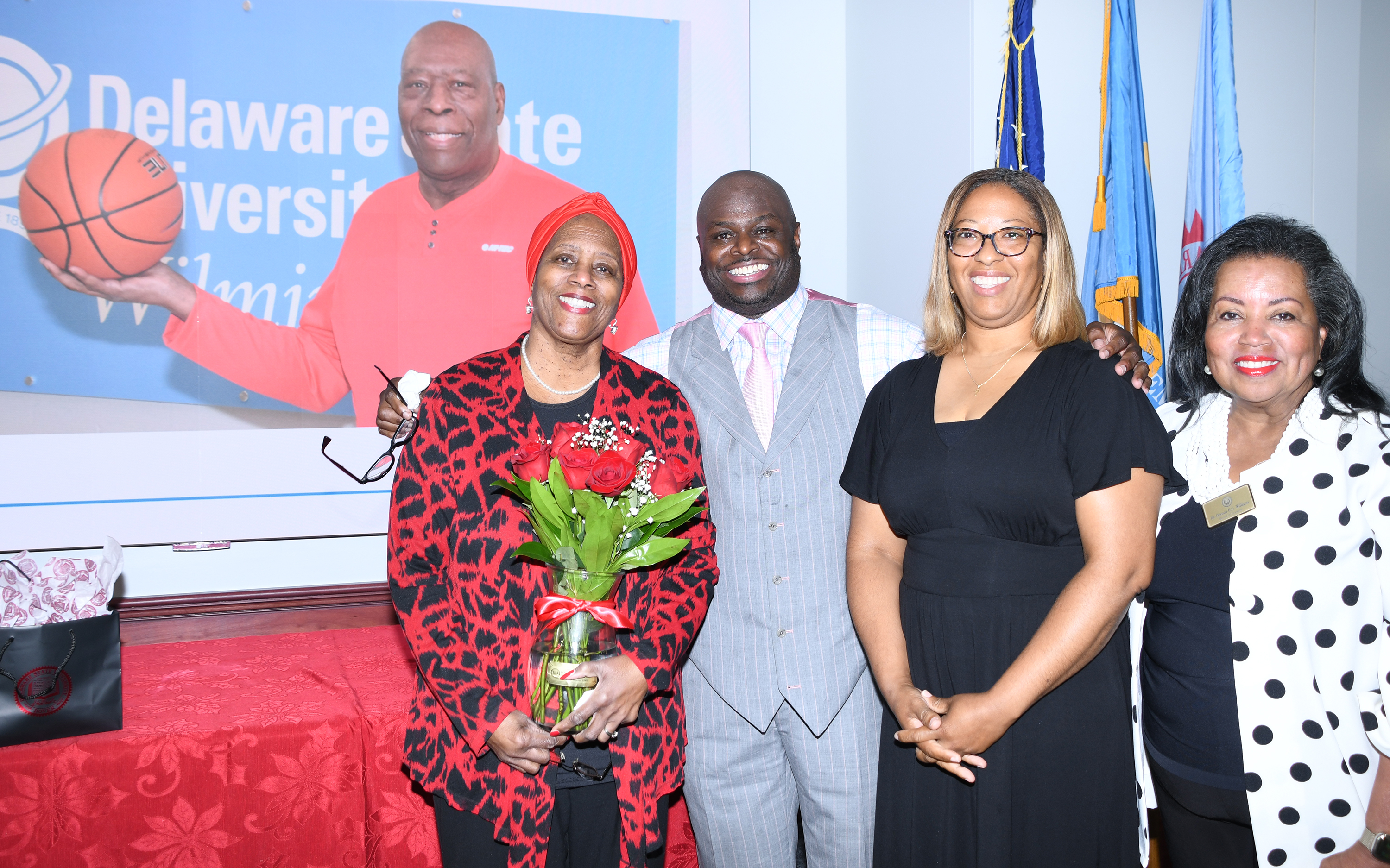 Dr. Allen stands with Juanita Pritchett (l) and Nicole Pritchett in front of an image of the late Maurice Pritchett.