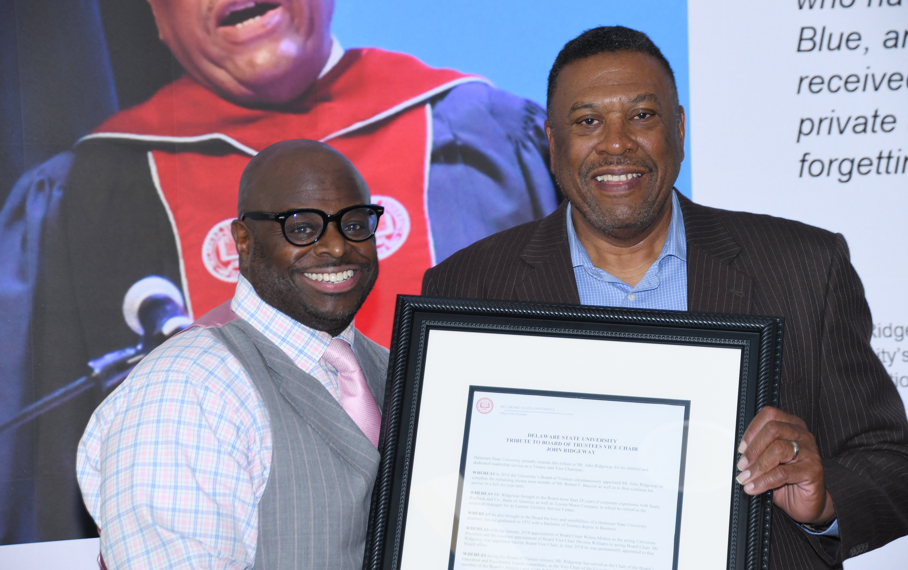 University President Tony Allen presents Trustee John Ridgeway with a Tribute.