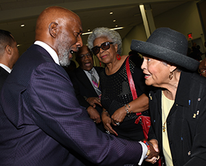 Prayer Breakfast keynote retired AME Bishop John Bryant talks with Betsy Williams.