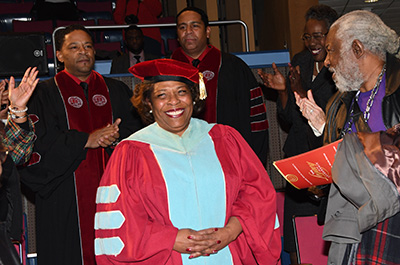 Dr. Wilma Mishoe receives a standing ovation as she enters the theatre for the Investiture Ceremony.