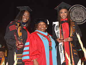 Destiny Wilkins (r) and Siara Bey received Presidential Leadership Award from Dr. Wilma Mishoe.