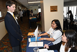 University student Karla Moreno and Itzel Braca-Morales check in a BPA competitor during the conference.