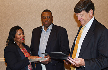 Dr. Devona Williams (l) is sworn in by General Counsel Tom Preston