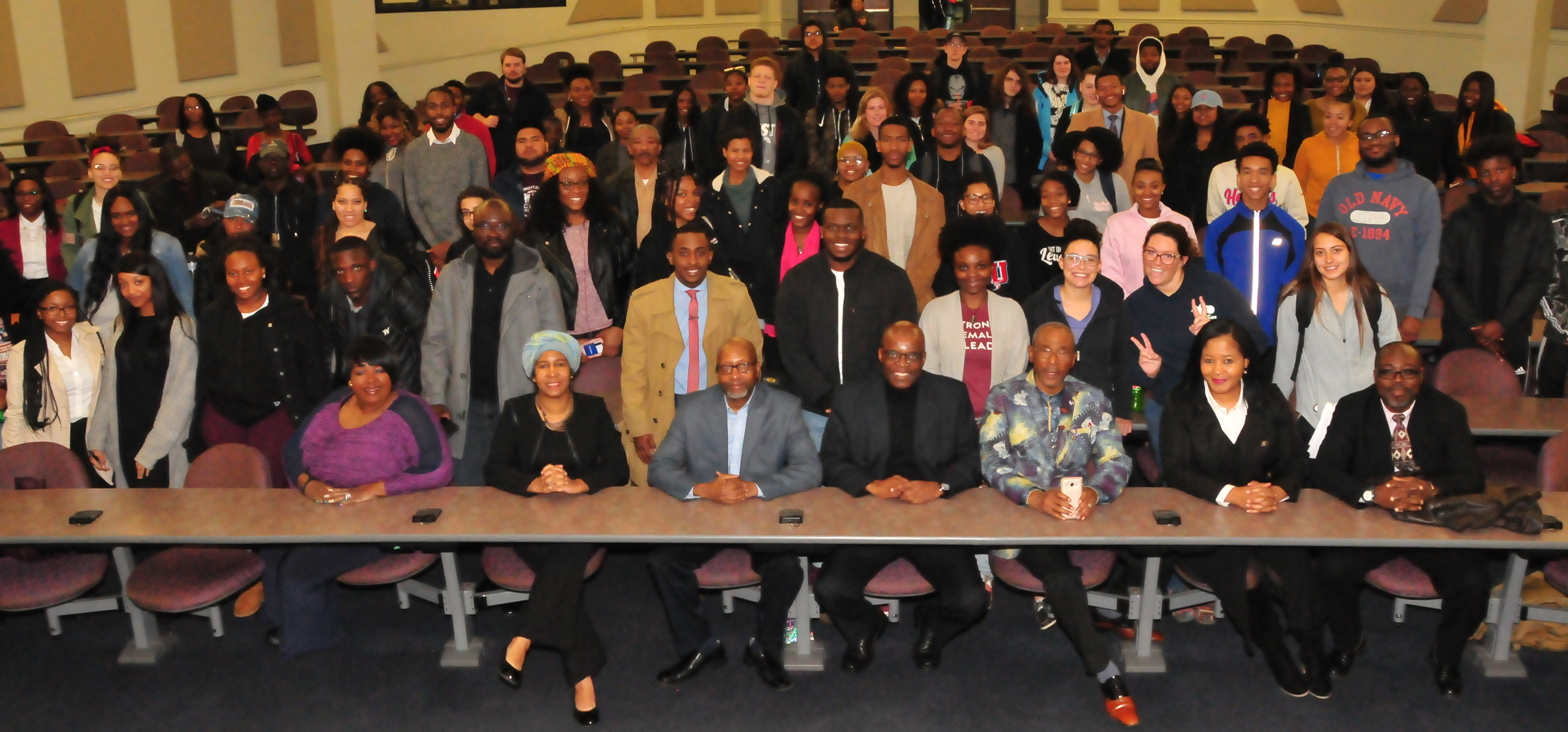 Dr. Eddy Maloka (seated center in dark suit) poses with the students who were his audience.