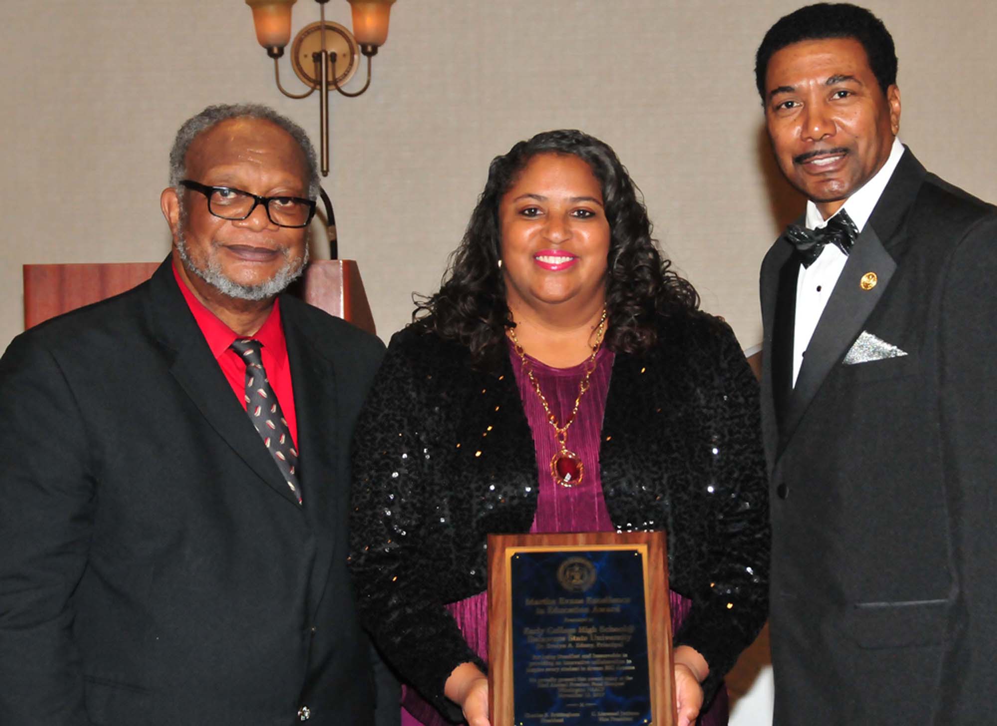 Dr. Evelyn Edney (center), director of the Early College HS, accept the award from the NAACP. 
