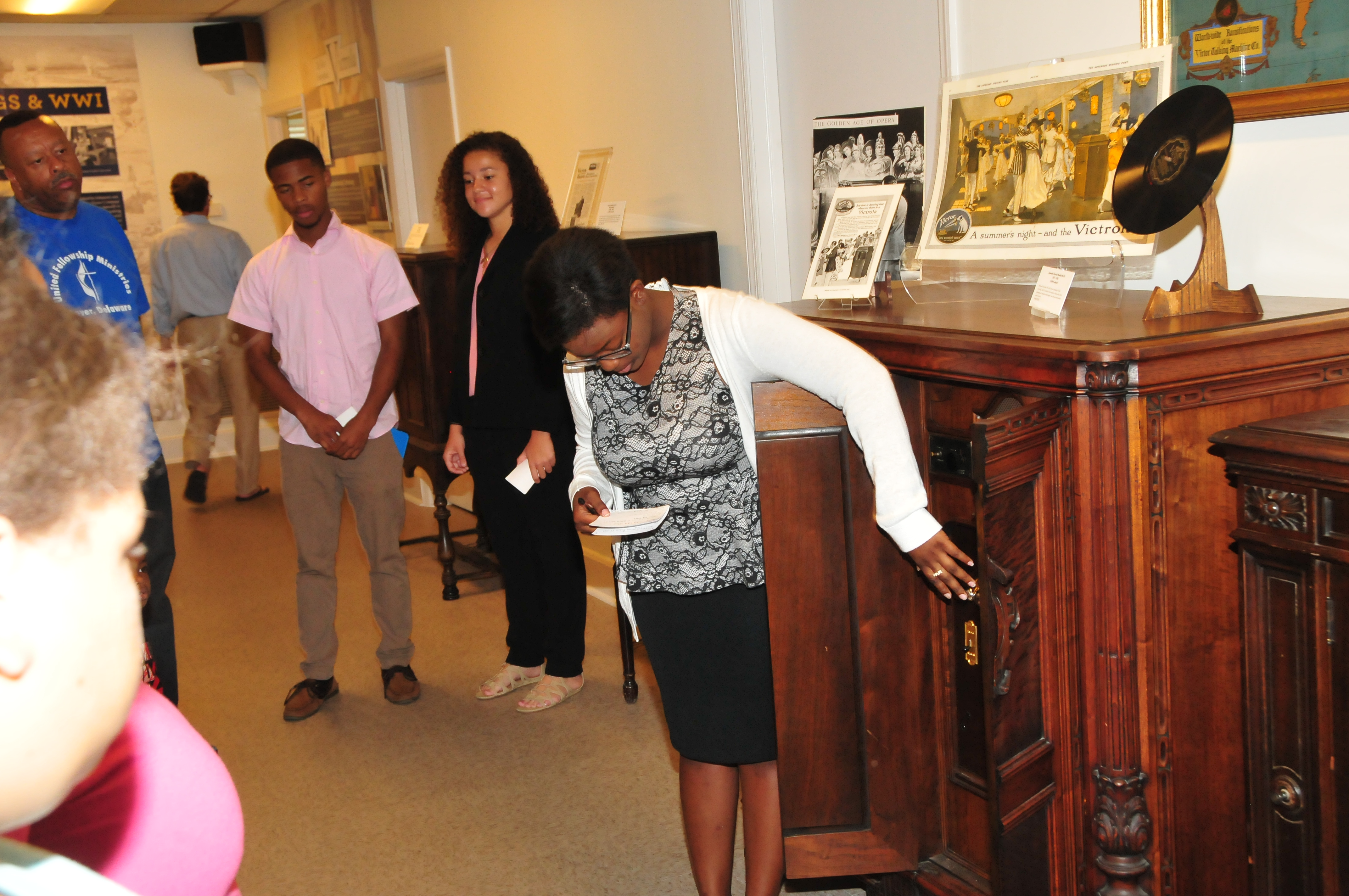 Tiarnique Washington show an antique stereo console at the Victrola Museum