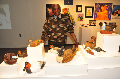 Mr. Gibson, shown with some of his works, has been an artistic carver of waterfowl decoys for more than 45 years.