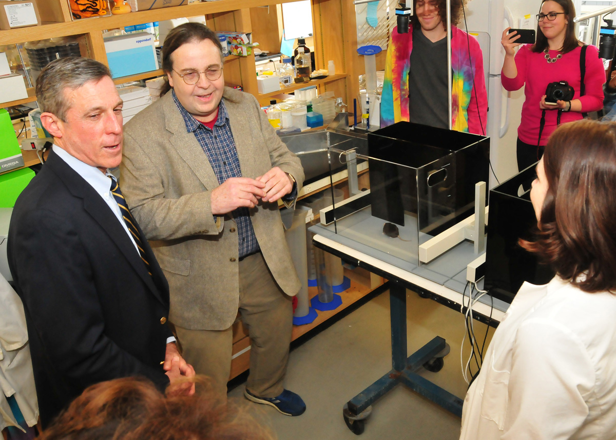 Gov. John Carney talks with Dr. Michael Gitcho and students about their Alzheimer research.