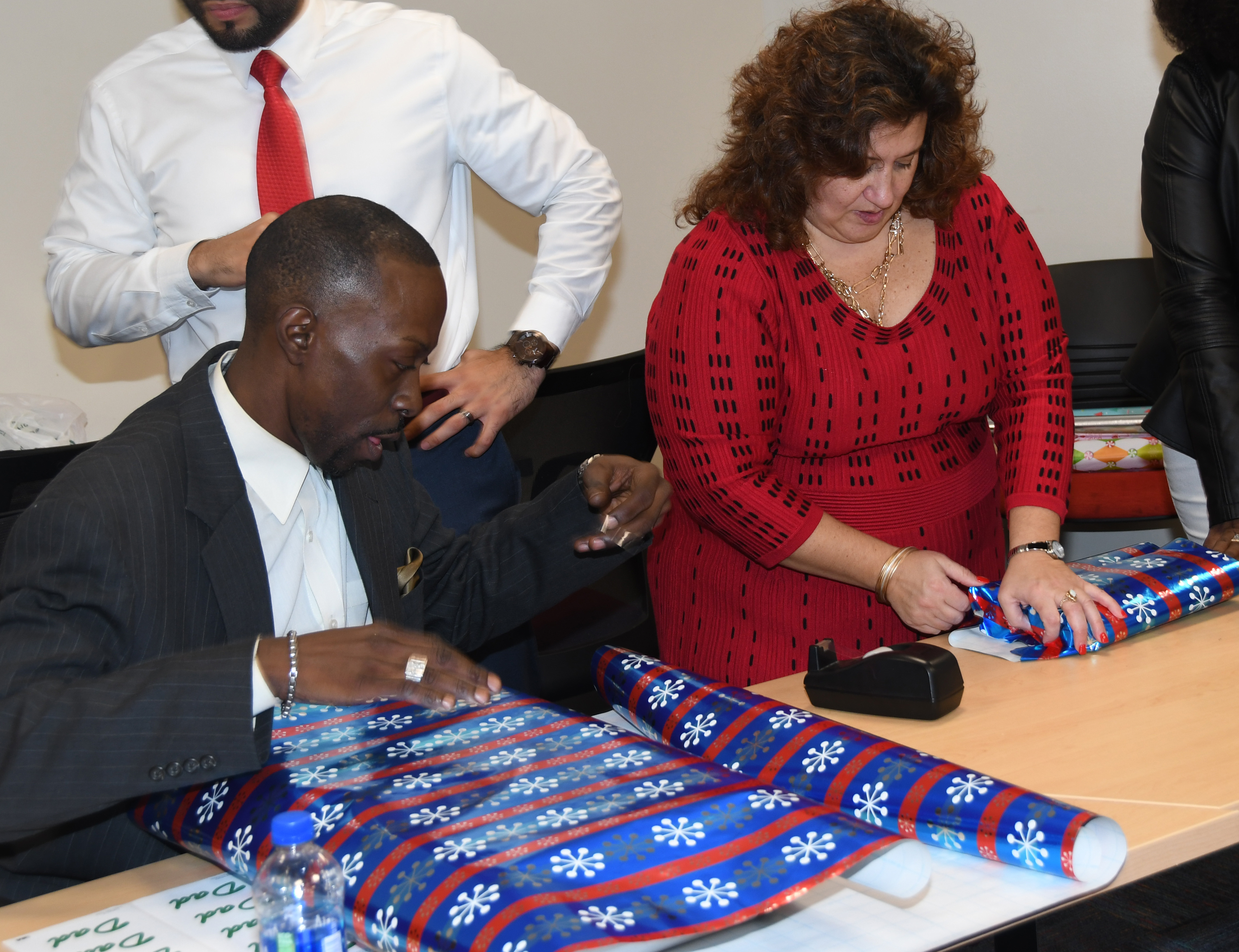 Office of Student Success members wrap gifts for two local families.
