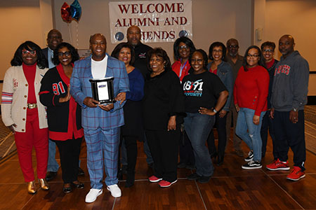 Ronnie Shaw Sr. celebrates the award with fellow Hornet alumni and University officials.