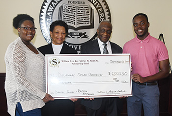 Rev. Shirley and Williams Smith (center) present scholarships to the University's Kaelya McEachin (l) and Daniel Sanvee.