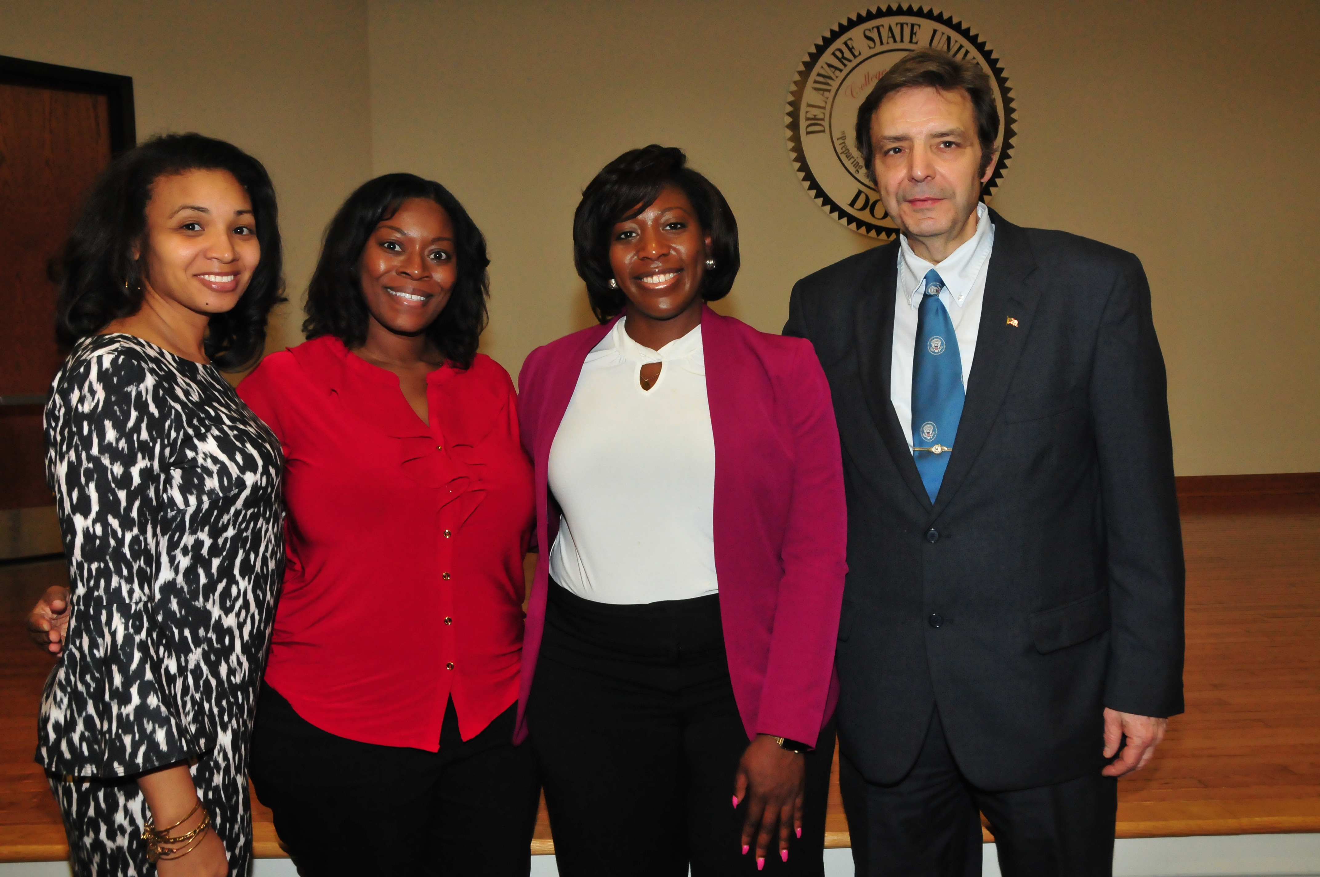 Del. Barrister Association judges Jordan Perry, Esq., Loren Holland, Esq., and Brionna Denby, Esq, alone with DSU Dr. Sam Hoff.