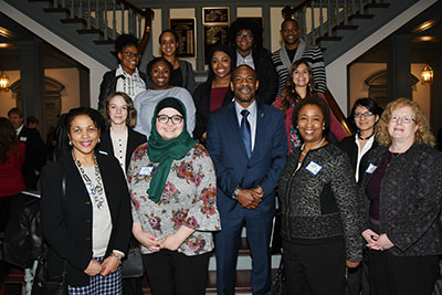 Rep. Nnamdi Chukwuocha poses at Legislative Hall with visiting University students and faculty.