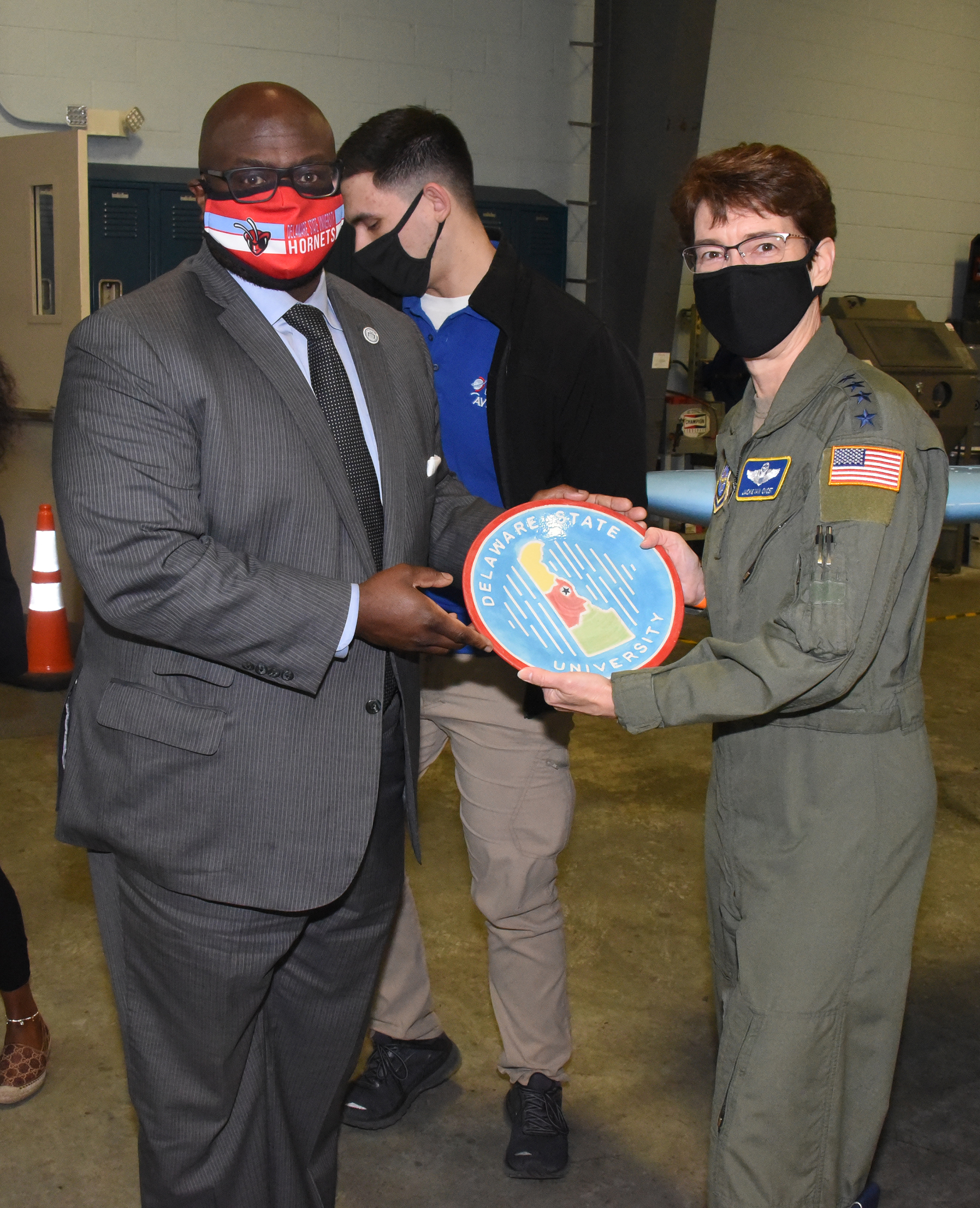 University President Tony Allen presents Gen. Van Ovost with a Del State plate.