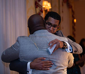 Dr. Tony Allen shares a congratulatory hug from Wali Rushdan II, attorney and award presenter.