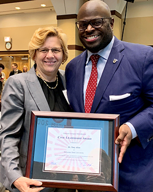 University Provost Tony Allen holds his Civic Leadership Award with Dr. Roberta Cordano, president of Gallaudet University.