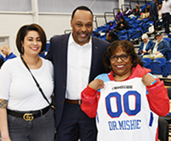 Dr. Wilma Mishoe shows off her Blue Coat basketball shirt with Jackie Griffith and James Collins.