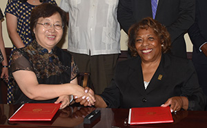 Dr. He Ran of Changchun University shakes with Dr. Wilma Mishoe after signing an amended agreeement between the two schools.