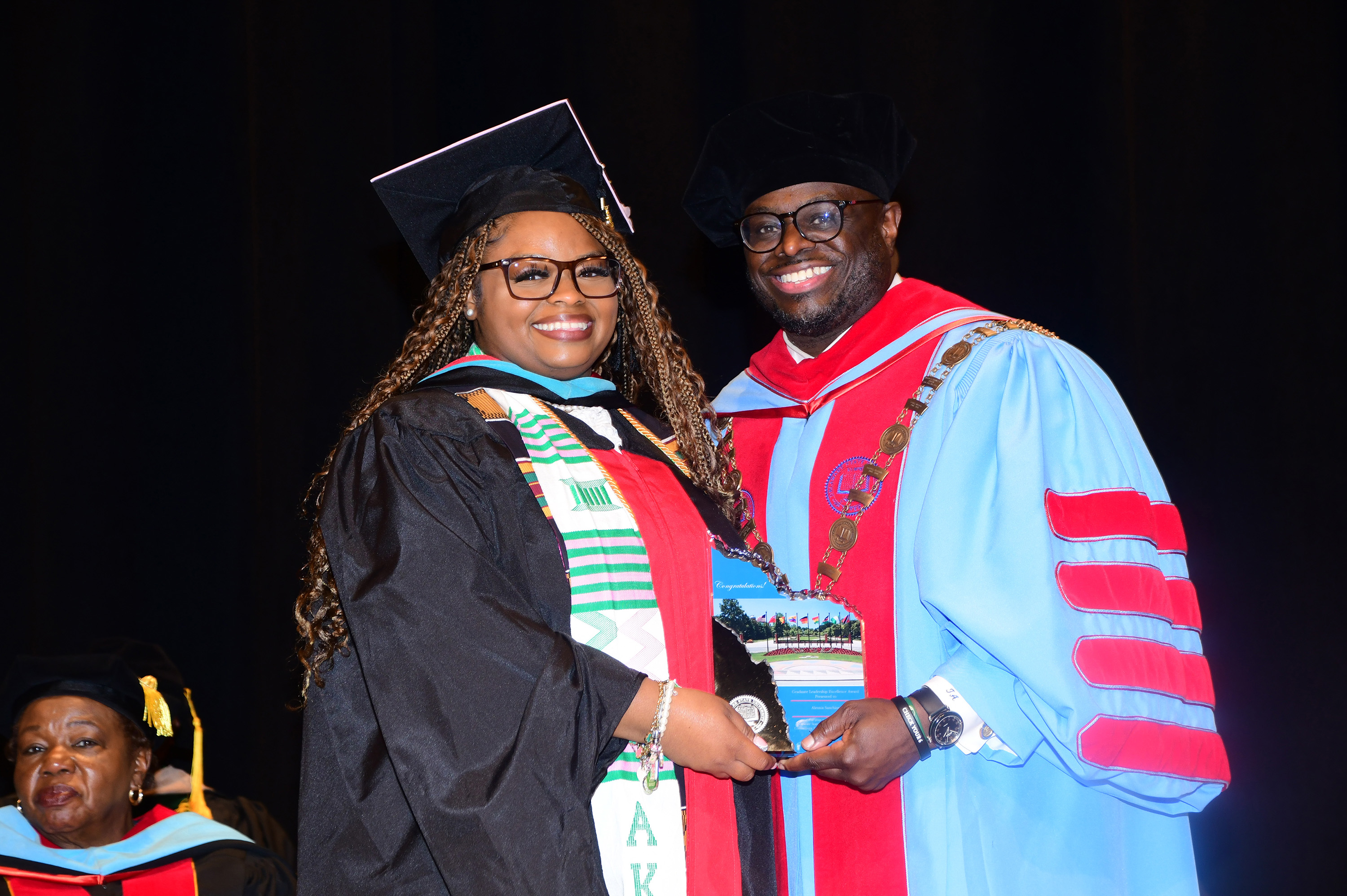 Alexxis Sanchious received the Graduate Excellence in Leadership Award from Dr. Tony Allen.