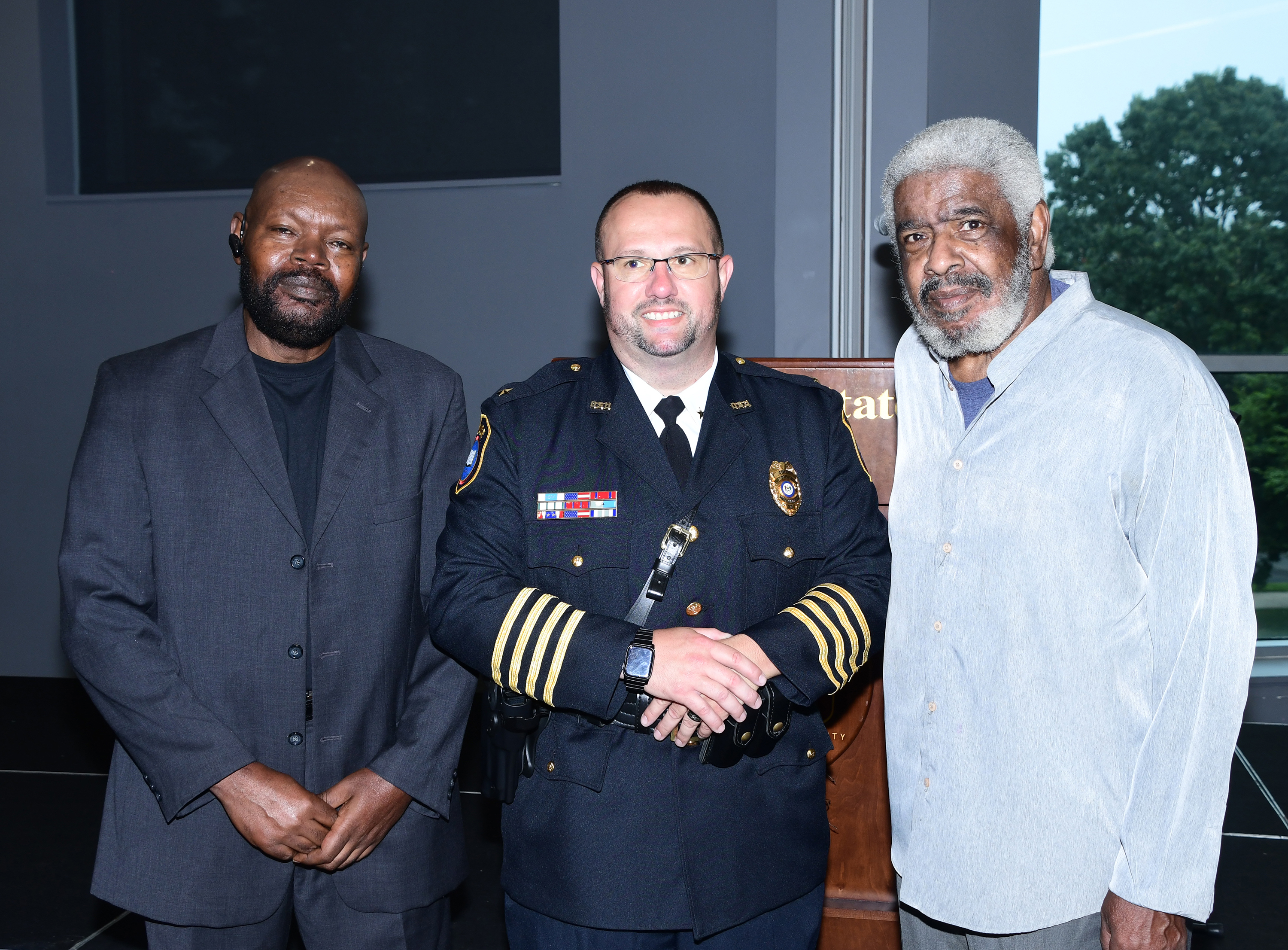Former dispatcher Butch Paige (l) and security officer Bruce Thomas (r) pose with Chief Baynard.